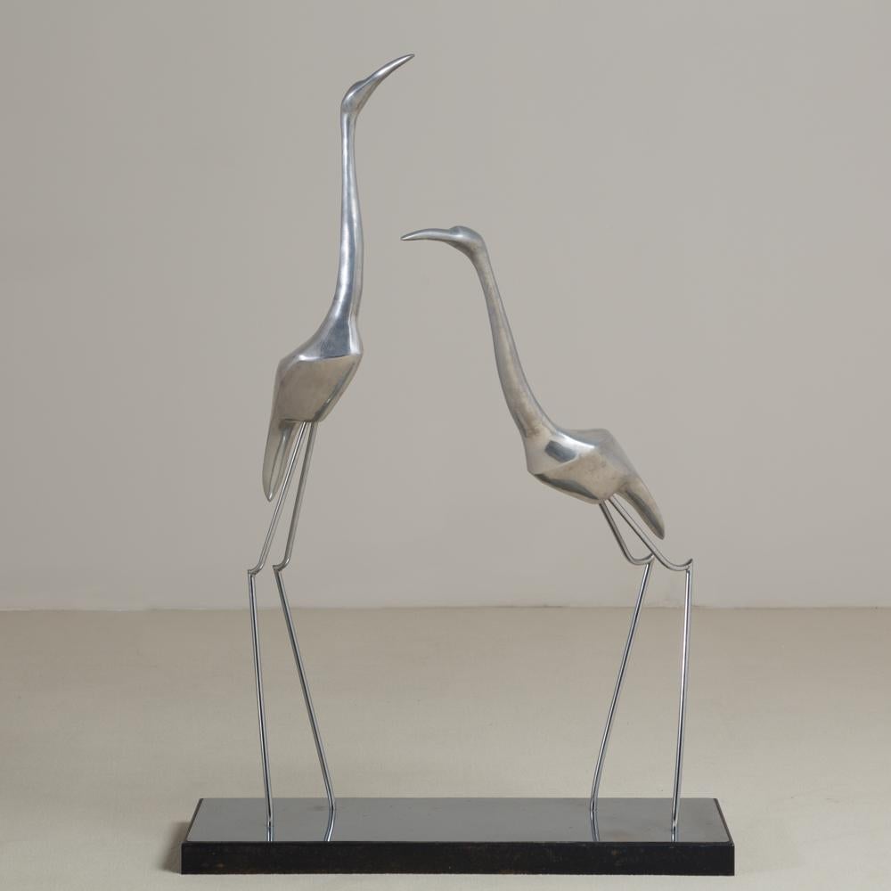 A large polished chrome sculpture depicting two cranes by Curtis Jere signed, 1980s
Could be used as a table sculpture or floor standing piece 

Curtis Jeré is the collaboration of two metal sculptors Jerry Fels and Curtis Freiler who founded the