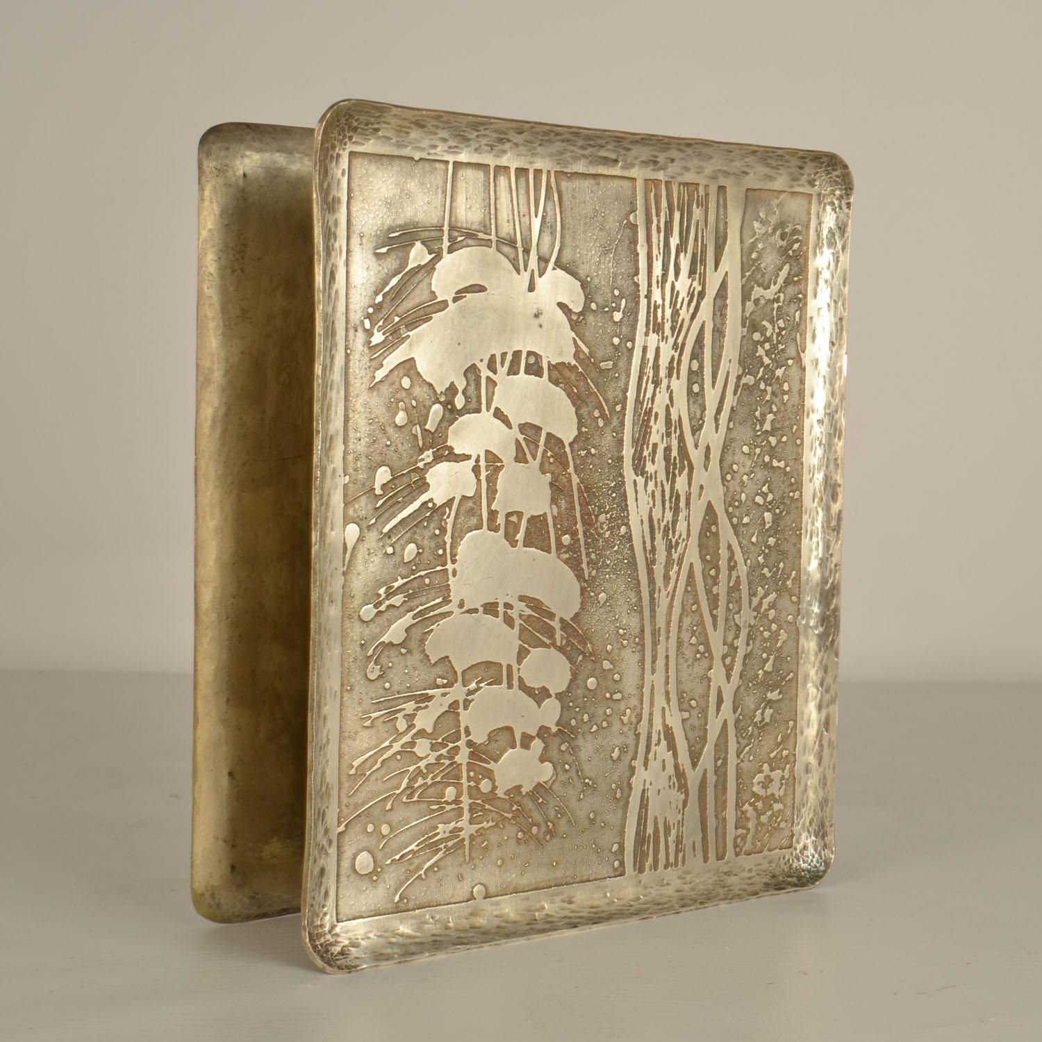 Rare pair of hand made rectangular door handles in hammered copper with strong abstract plant motive created by etching is silver plated. The handles show patina through age that suits the relief very well and reveal tiny edges of copper through the