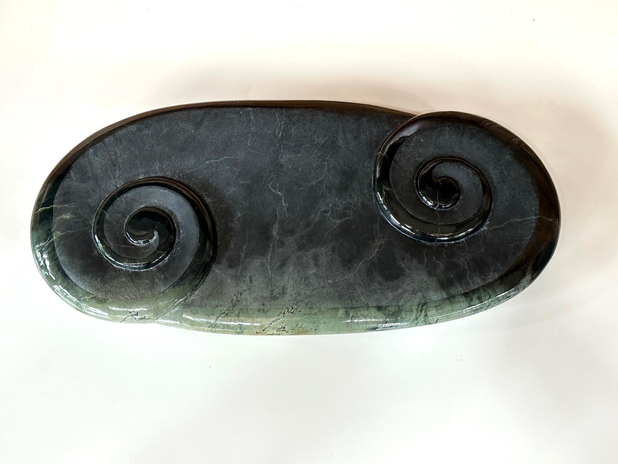 An impressively large jade sculpture for table or desktop. In Māori style from New Zealand, the heavy jade Nephrite slab (also known as “pounamu”) was carved and polished into the 