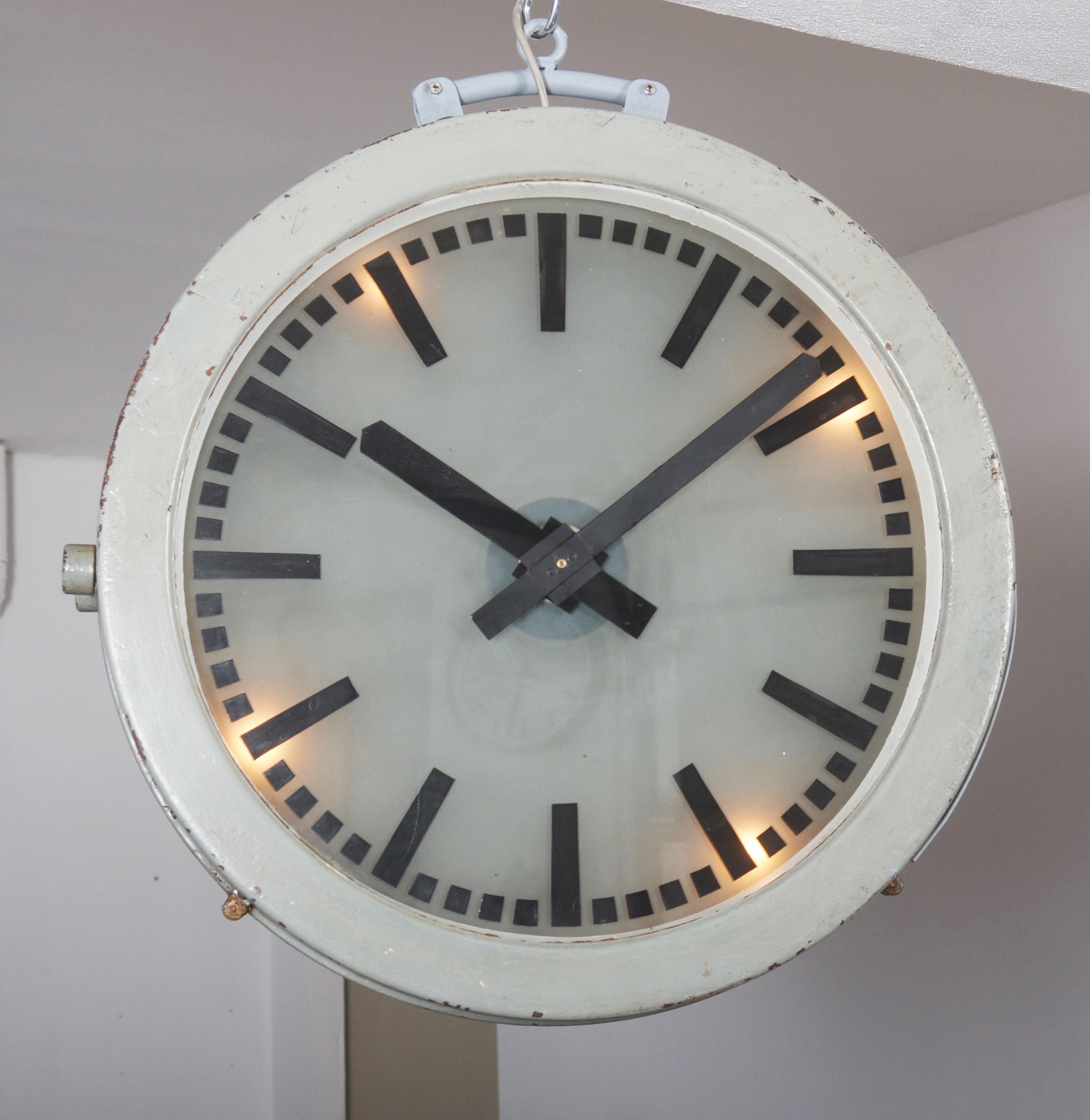 Large German station or factory clock probably by Telenorma (TN) or Siemens Halske from the early 1930s. Steel frame paited with 2 glass clock faces fitted with 4 E14 bulbs, formerly as a slave clock with mechanical movement but now rebuild to a