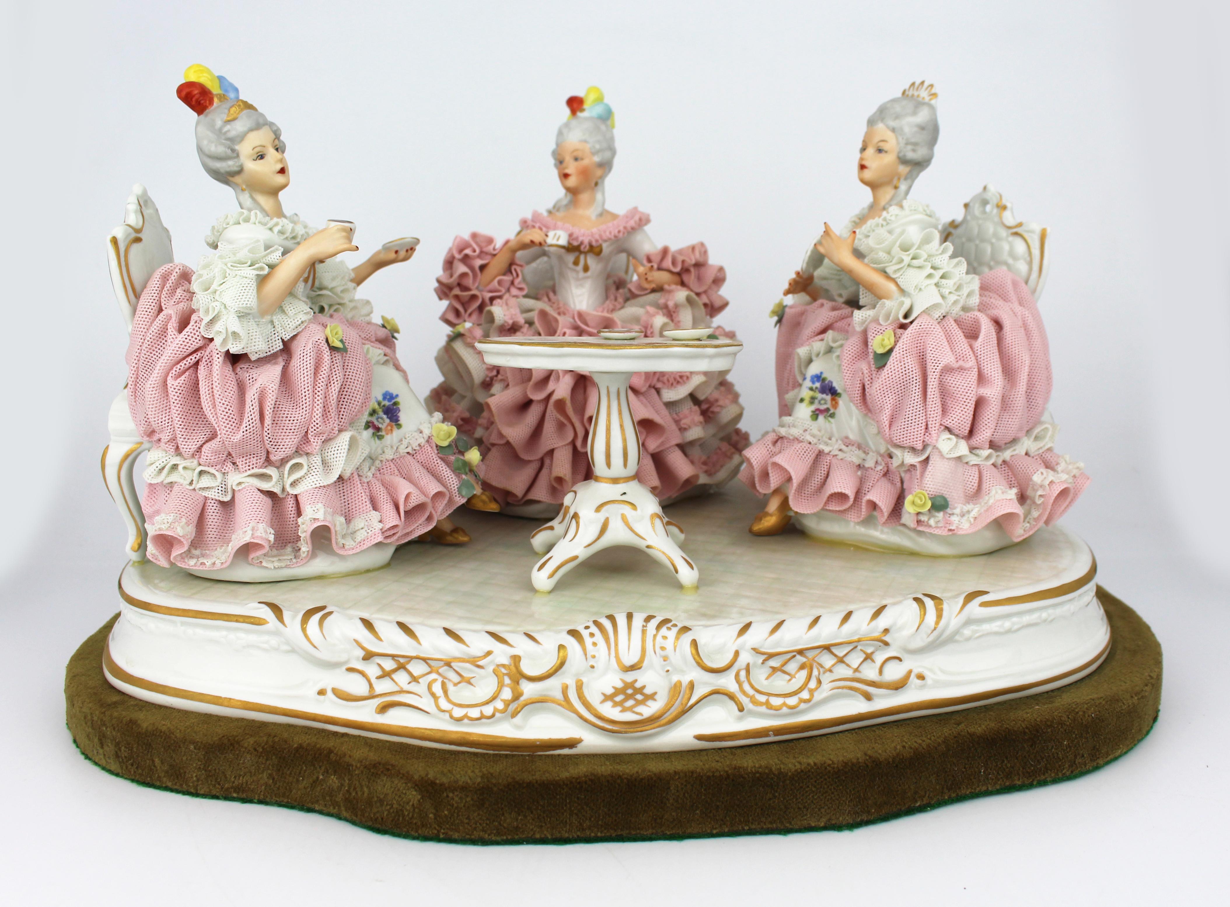 Large Dresden Porcelain “The Tea Party” Figural Group on Velvet Base, 20th Century

Description:
An elegant and finely crafted Dresden porcelain figural group depicting an 18th-century tea scene. Three aristocratic ladies are seated around a central