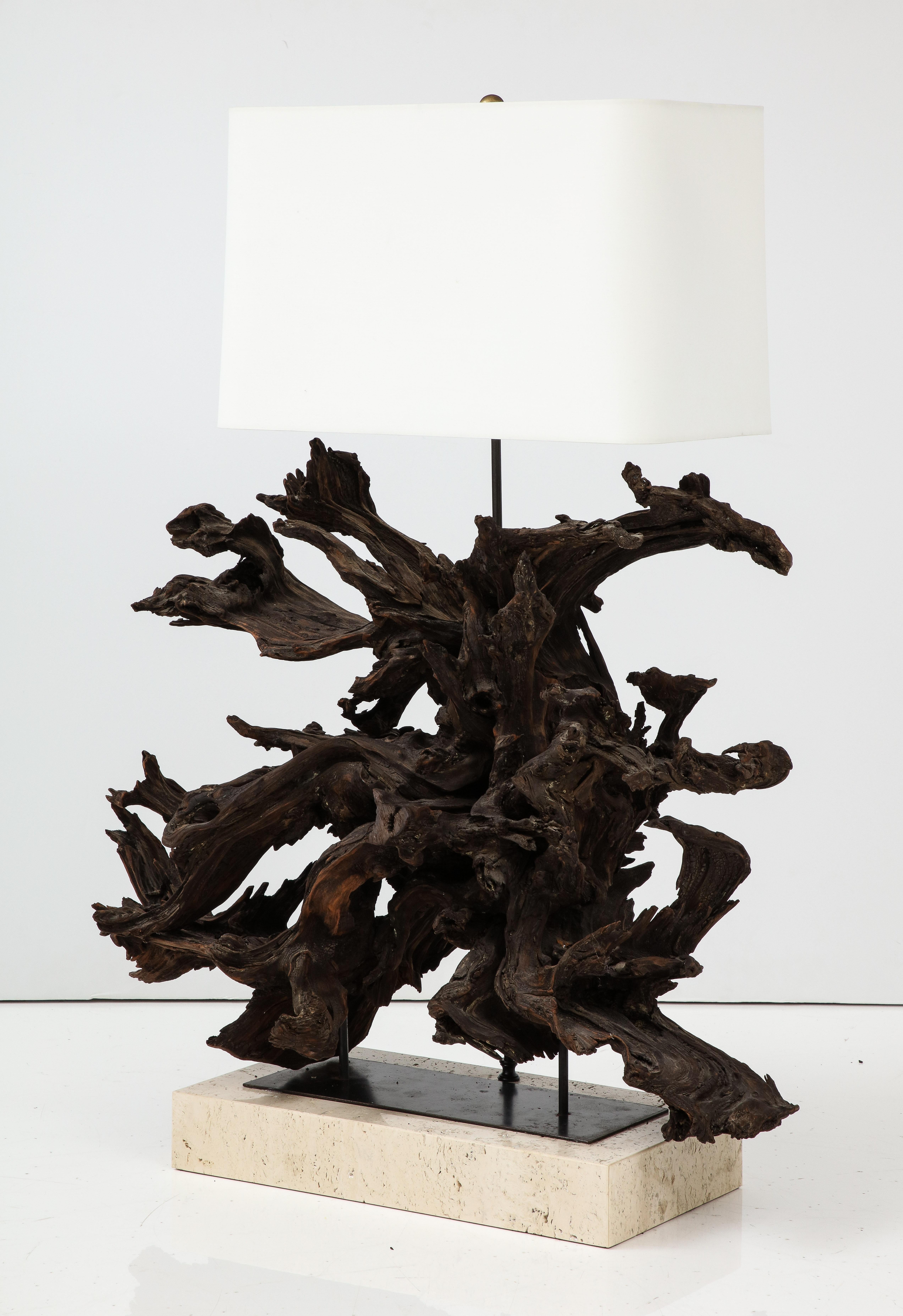 Large sculptural driftwood lamp on a travertine base.
The lamp has been Newly rewired with silk rayon cord and adjustable 
Antique brass double cluster that take standard size light bulbs.