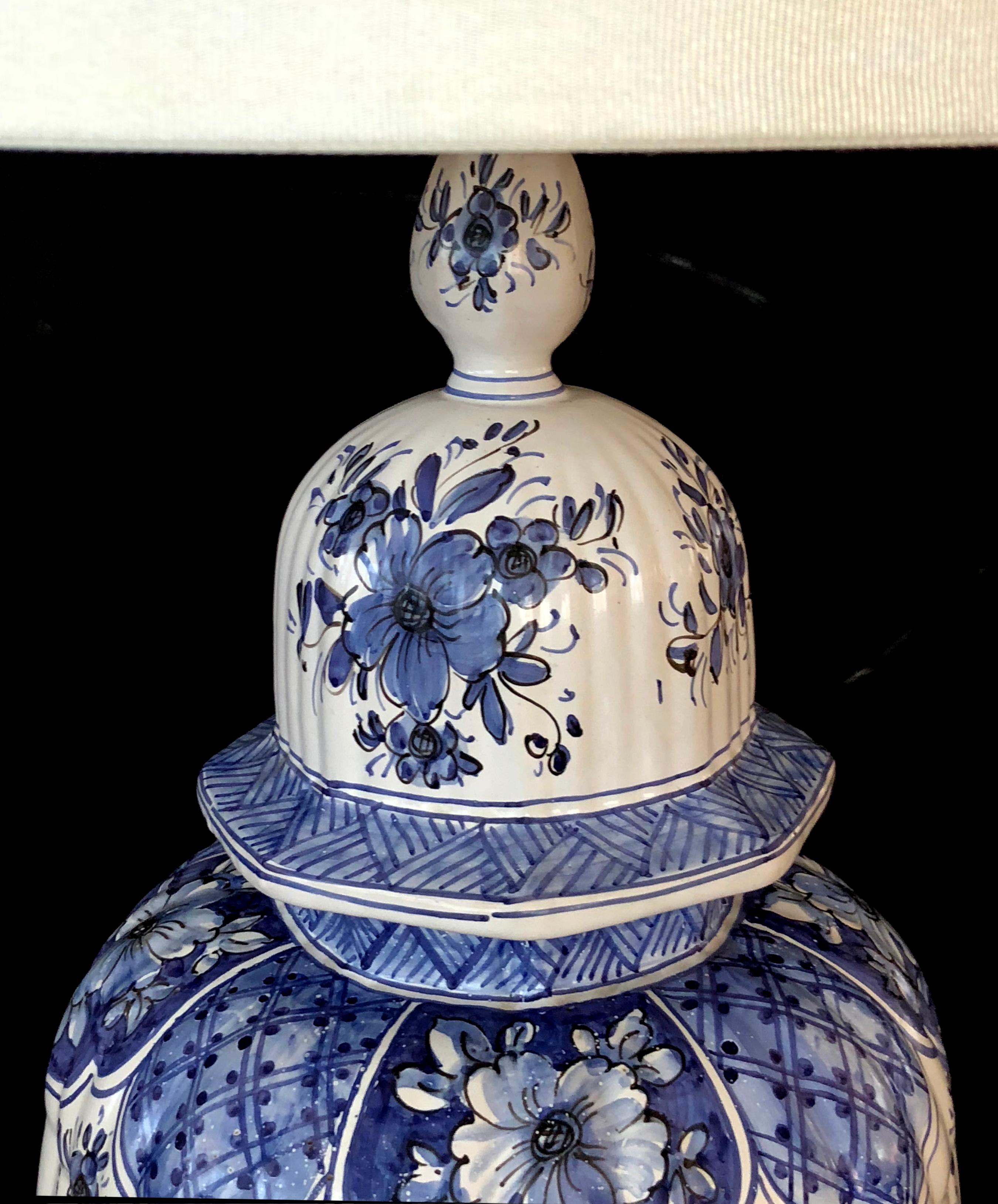 A large and good quality Dutch 19th century blue and white tin-glazed delft ginger jar now mounted as a lamp; of impressive size, the lidded ginger jar with domed lid and tapering lobed body with under-glaze blue decoration of vibrant flower heads