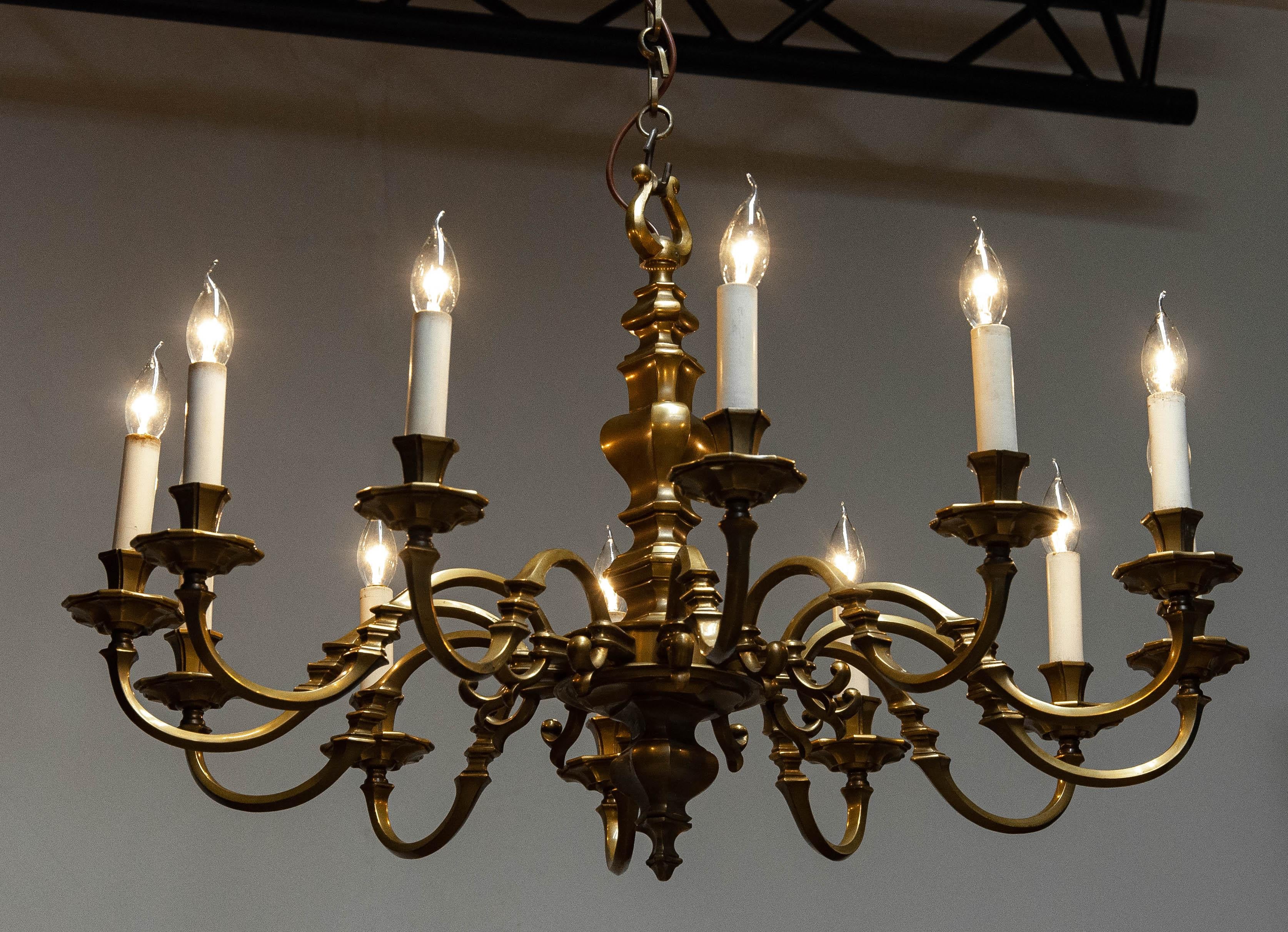 Absolutely stunning and large ( ø 39 Inches 100cm ) high quality Dutch Colonial / Baroque style chandelier in brass with twelve arms each supporting a candle with a E14 screw fitting. True the years the brass has become a beautiful patina  what
