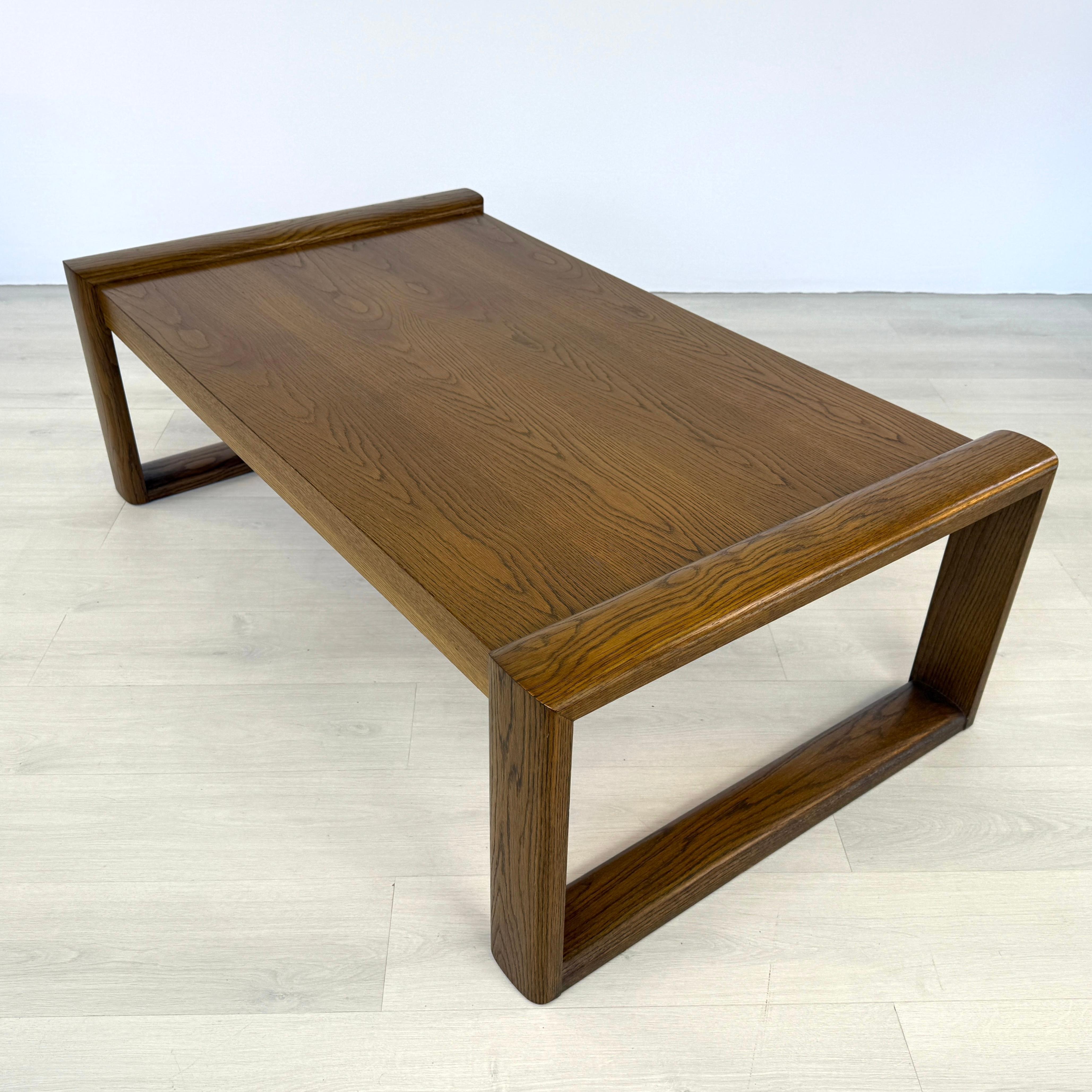 Dimensions: H 18” x W 57.5” x D 32”

Vintage large Brutalist rectangular oak sleigh coffee or side table attr. to Gunlocke from 1970s. Vintage furniture is great for the environment, for your home, and for your wallet. A wonderful addition to your