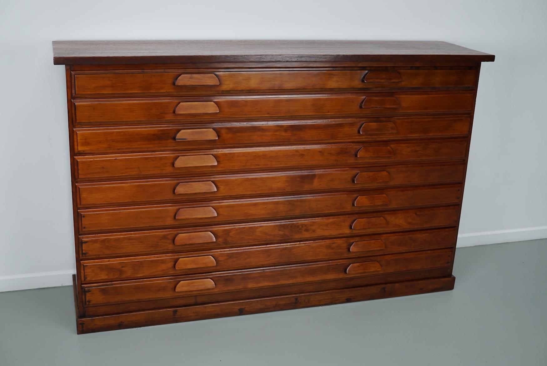 This cabinet was produced during the 1950s in The Netherlands. It features 9 large sized drawers. The interior dimensions of the drawers are: D W H 33 x 160 x 6 cm. It was used in a Catholic church as a chasuble cabinet.