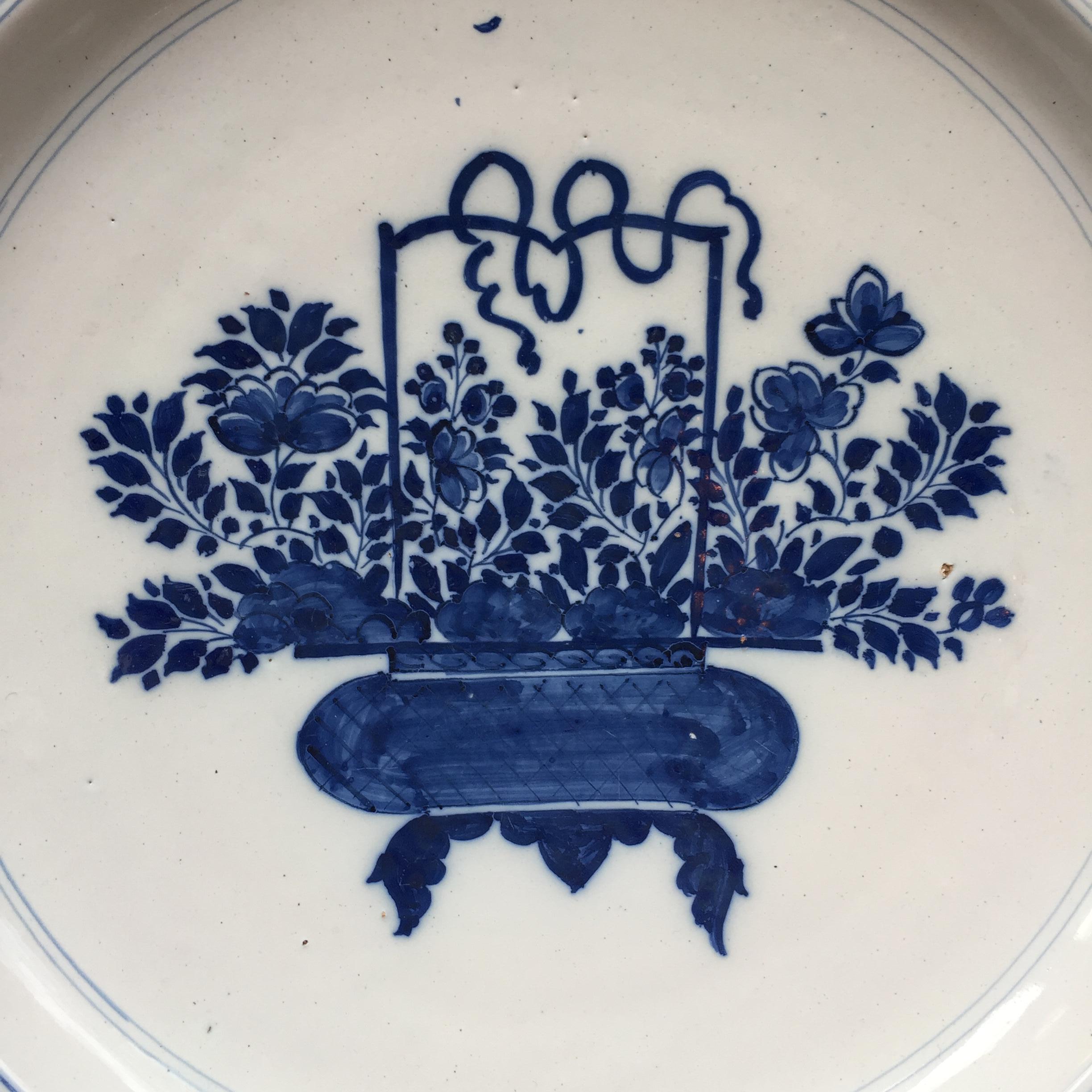 City: Delft
Workshop: Unknown
Date: circa 1700 - 1750

A fine blue and white plate with decoration of a Chinese flower basket.
Inspired on the Chinese Kangxi porcelain.
With a small border decorated with branches

Unmarked

Provenance: Morpurgo