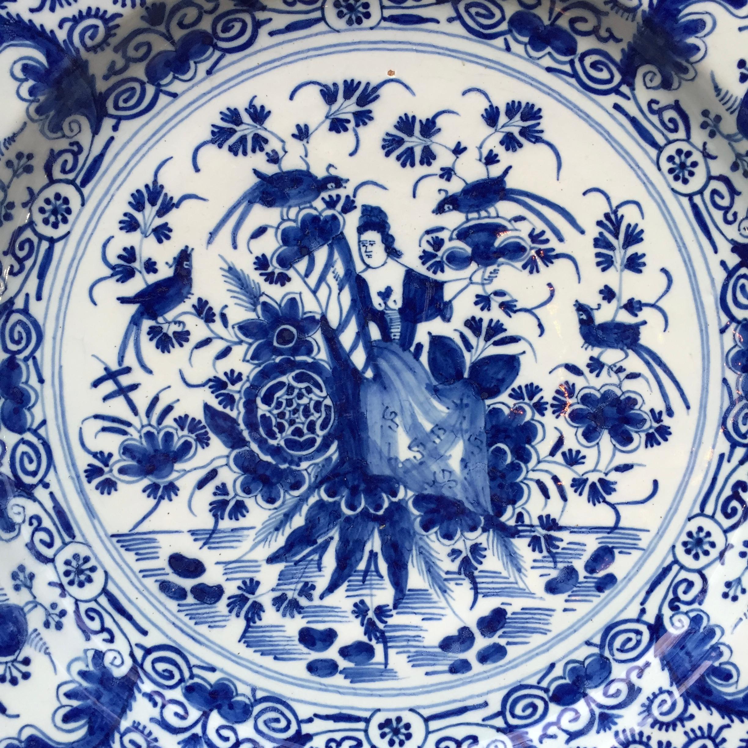 City: Delft
Workshop: De proceleyne Bijl (The porcelain Axe)
Date: circa 1730 - 1760

A fine blue and white plate with decoration of the Lady Fortune, holding a cornucopia, seated in a Garden with flowers and birds.
Painted in a wonderful and