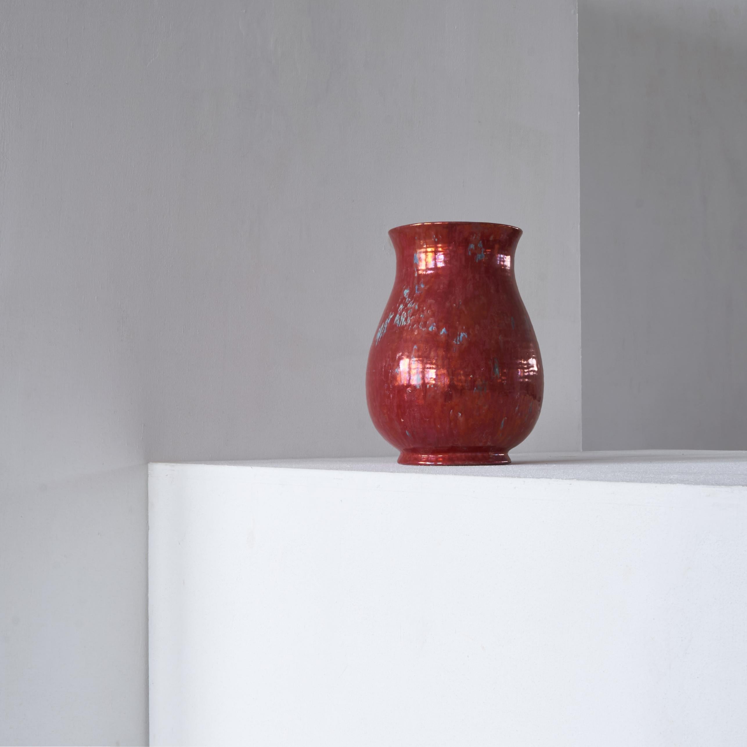Very large vase in red ‘Reflet Metallique’ by ‘De Porceleyne Fles’ Delft, around 1900.

Due to the metallic glazing this vase looks incredibly modern for it's age. The height and shape also add to this modern aesthetic. Therefore this vase will