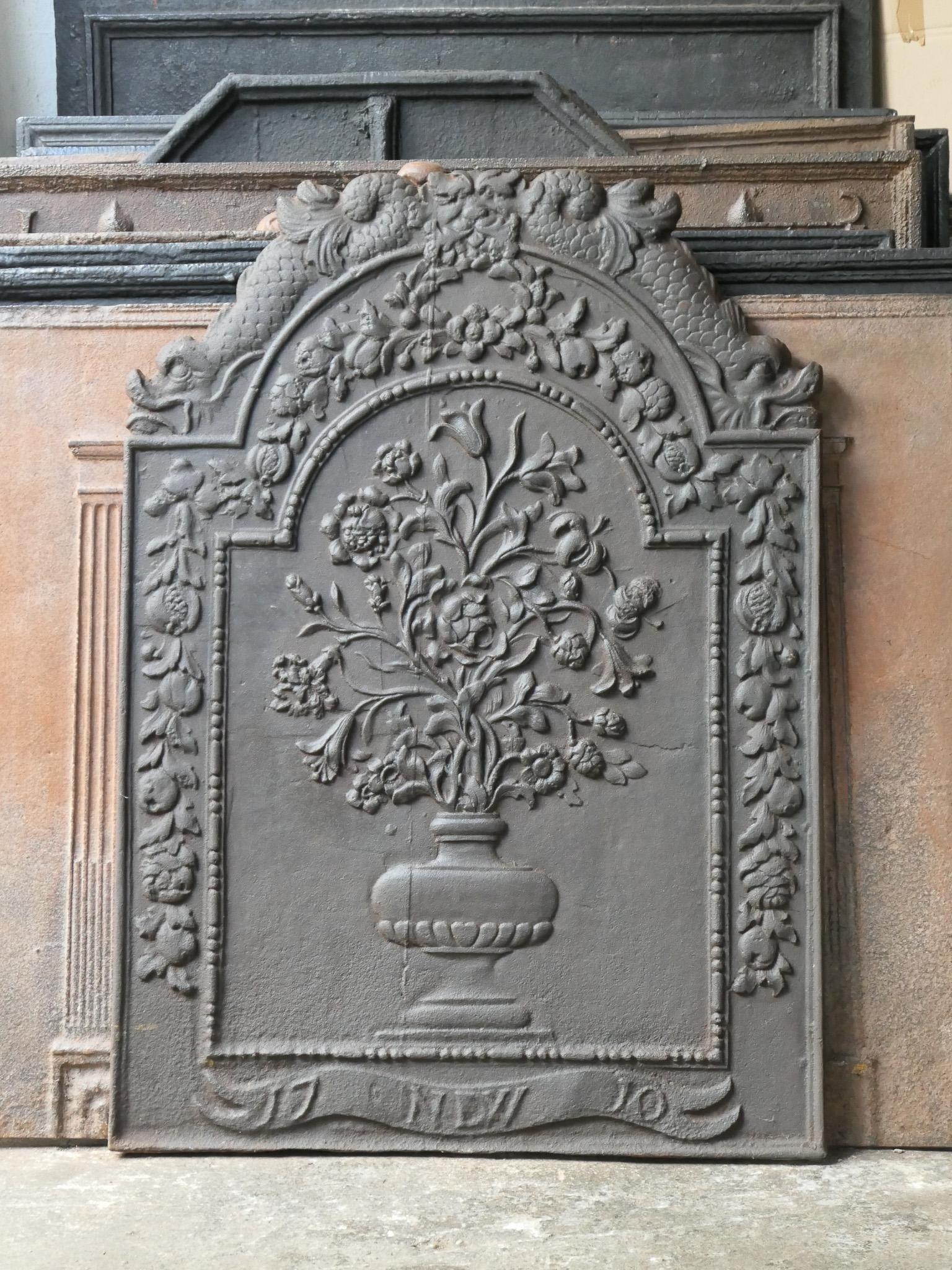 Large, elegant 18th century French Louis XV fireback with a flower basket.

The fireback is made of cast iron and has a black / pewter patina. The condition is good. It does not have cracks.

This product weighs more than 65 kg / 143 lbs. All our