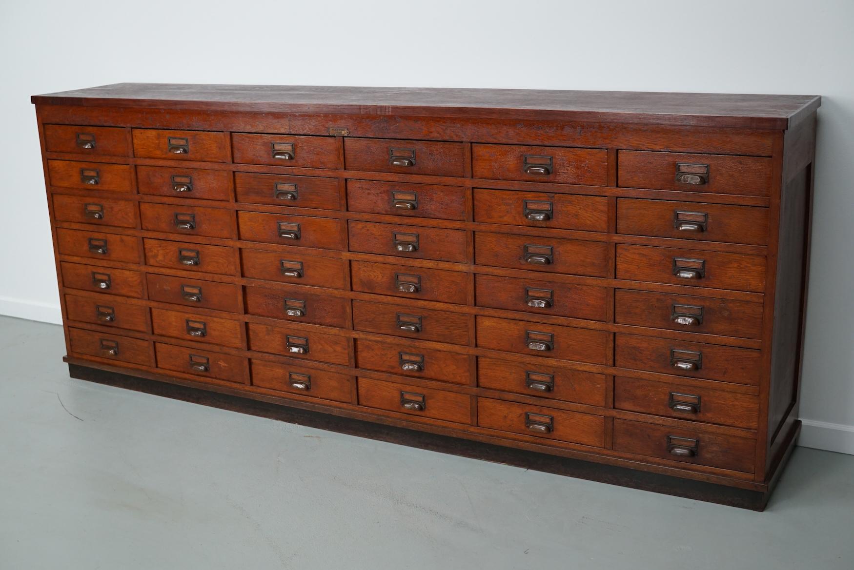 Este mueble de botica / tienda se fabricó durante la década de 1930 en Holanda. Tiene 42 cajones con herrajes de latón y se conserva en buen estado vintage. Las dimensiones interiores de los cajones son DWH 31 x 31 x 7 cm.