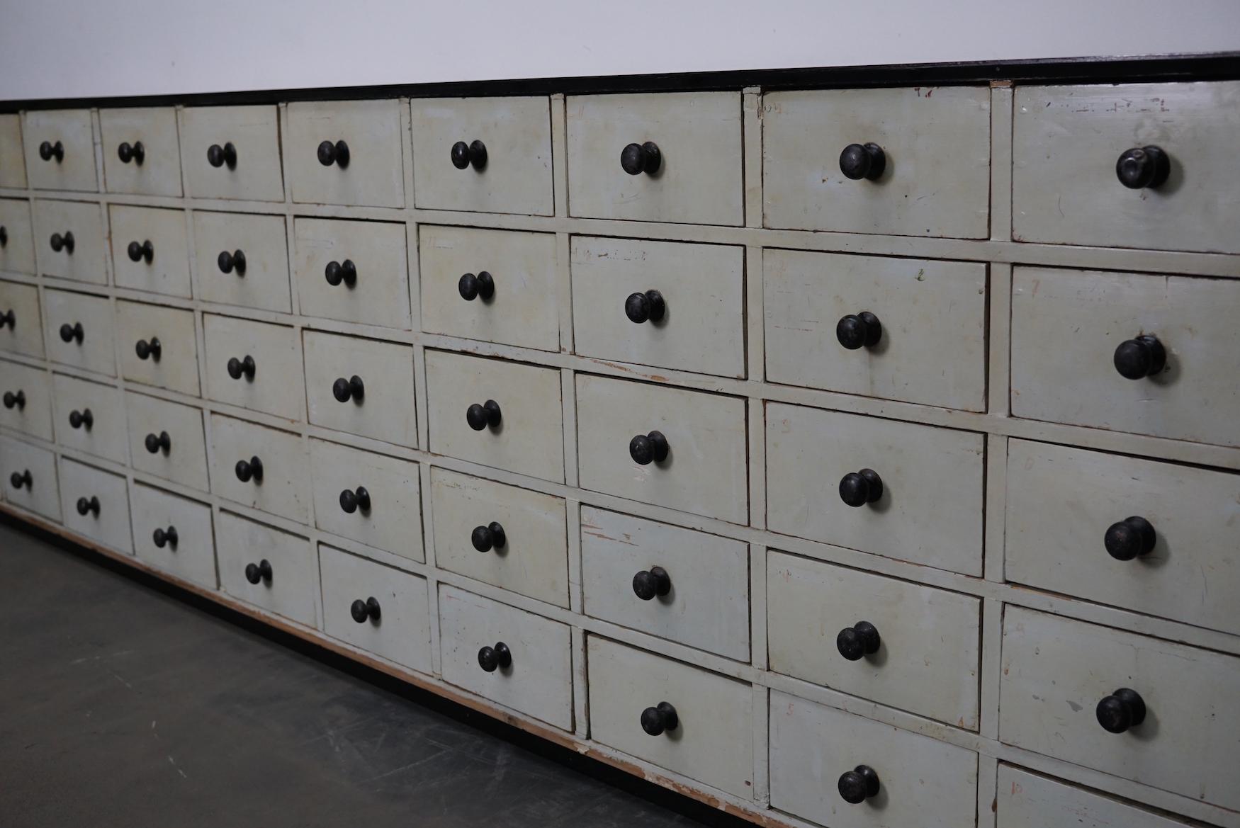This cabinet was produced during the 1950s (or earlier) in the Netherlands. It was used in a workshop. This piece features 60 mint blue / green / grey pine fronted drawers with nice metal knobs. The interior dimensions of the drawers are: D x W x H