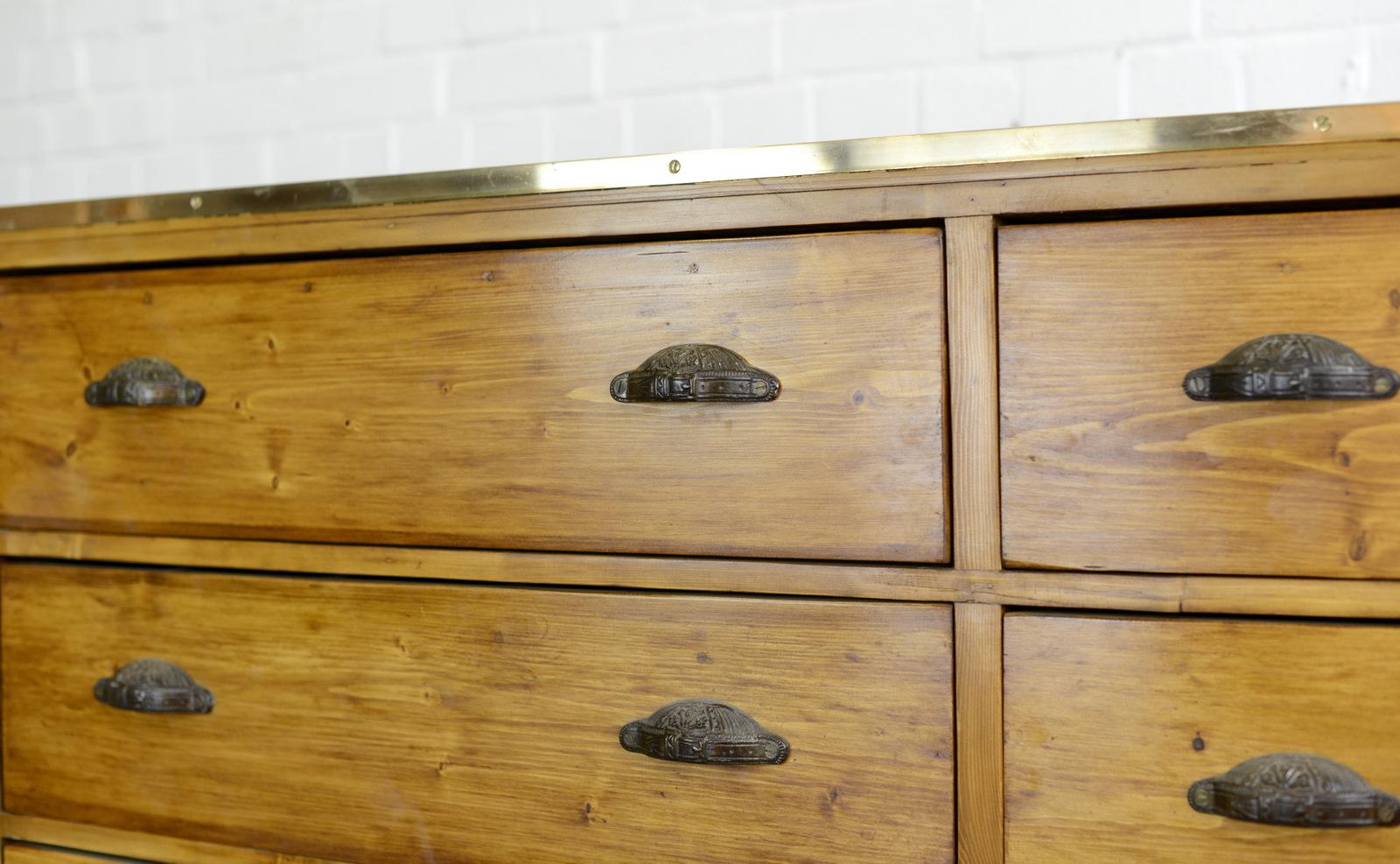 Large Dutch tailors drawers, circa 1910

- Price is per cabinet (2 available)
- Ornate cast iron handles
- Brass edging
- Solid pine drawers
- Salvaged from a tailors in central Amsterdam
- Dutch, 1910
- Measures: 171cm wide x 76cm deep x