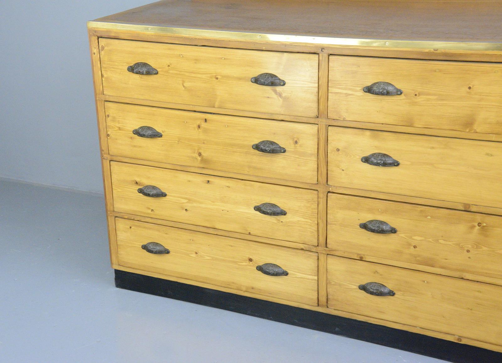 Large Dutch tailors drawers, circa 1910

- Price is per cabinet (2 available)
- Ornate cast iron handles
- Brass edging
- Solid pine drawers
- Salvaged from a tailors in central Amsterdam
- Dutch, 1910
- Measures: 171cm wide x 76cm deep x