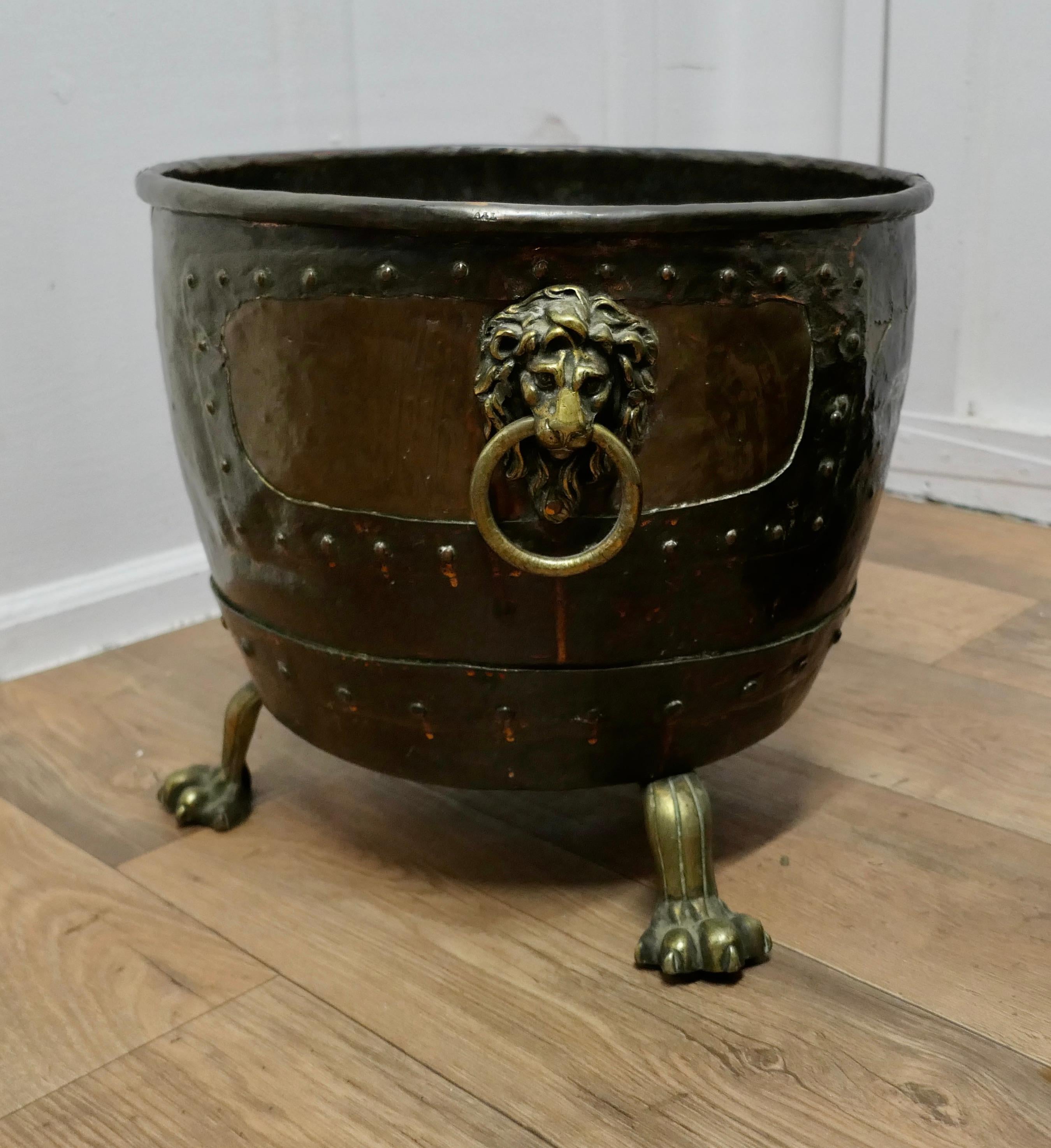 Large Early 19th Century Copper Log Cauldron

This is a lovely looking Cauldron, it has obviously been a much treasured piece, it has tinkered patches and riveted repairs
The bottom of the cauldron has been reinforced with a Terracotta lining making