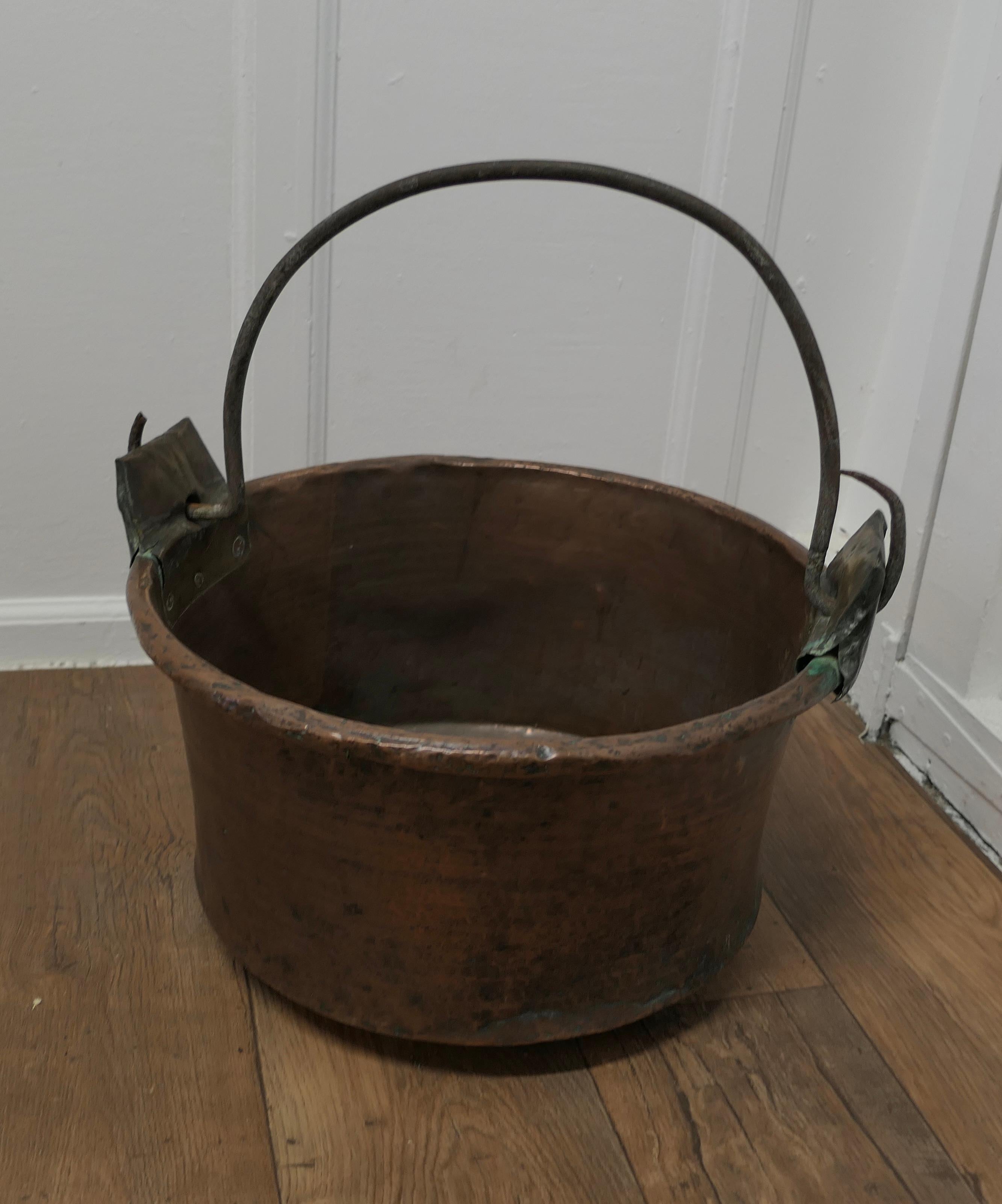 Large Early 19th century Copper Pan

This is a lovely looking Copper bucket, the pan was obviously a very treasured piece, it has a swing handle, which has been reinforced at both sides
The Pan is in good sound condition, obviously a much