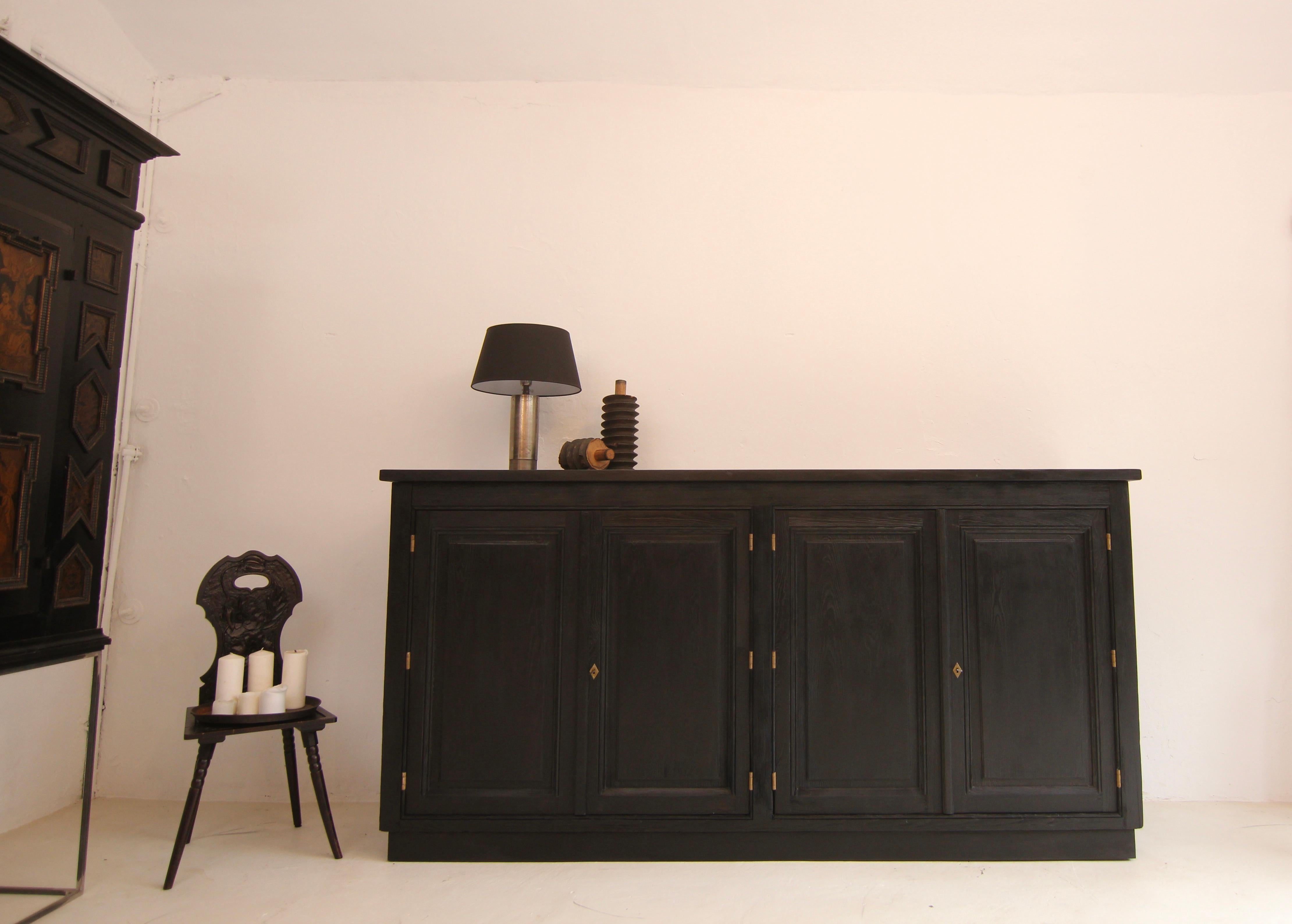 Large sideboard from a shop fitting. Around 1900, made of solid pine wood. Restored ready for everyday use.

Straight-lined pitch pine wooden body standing on a rectangular base in frame construction with 2 large lockable double doors and 3.5 cm