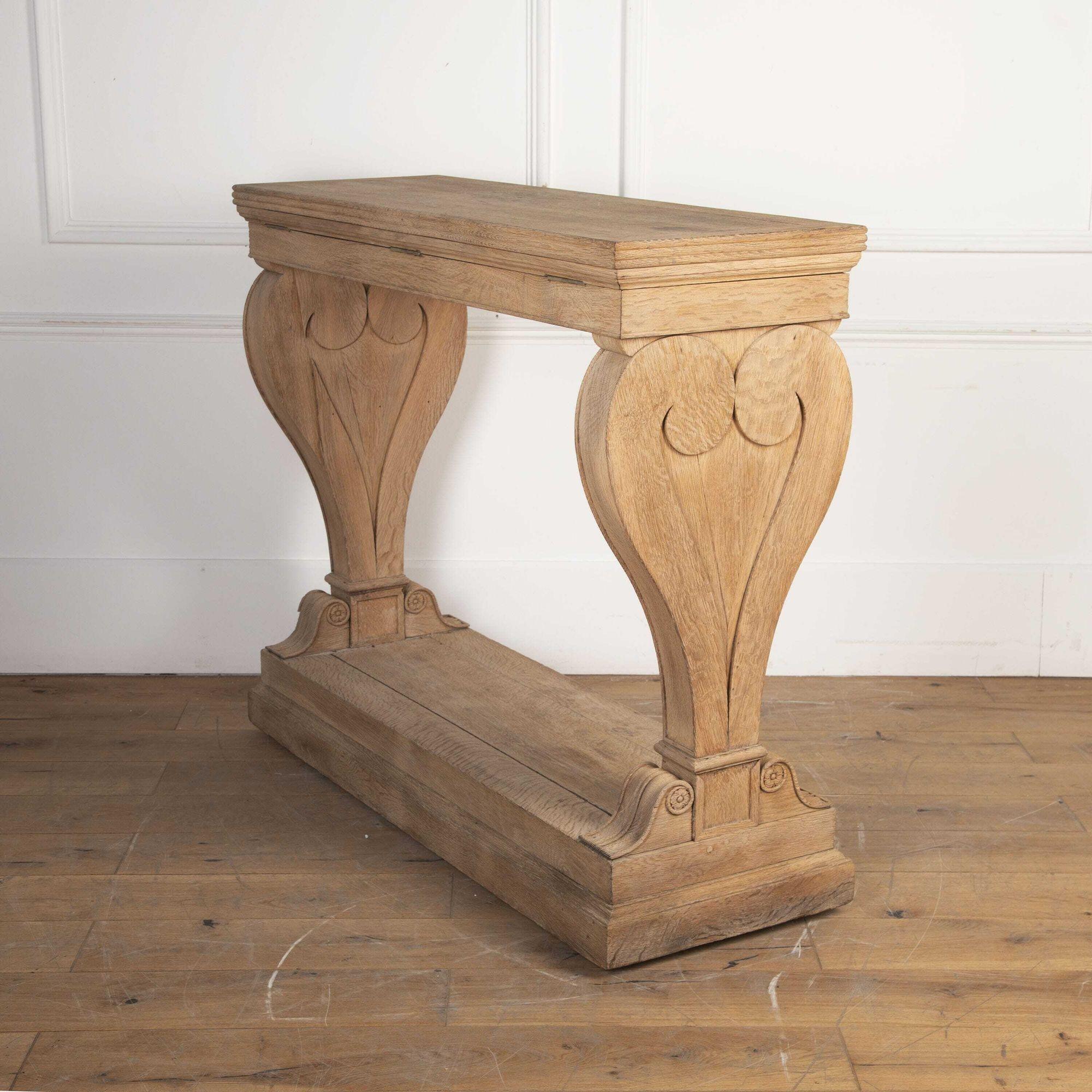 Early 19th century Empire console table.
Solid hand-carved bleached oak, a superb statement piece for an entrance hall or reception room.
The top is hinged to reveal an unusual hidden compartment, the use of which is now lost to history!.