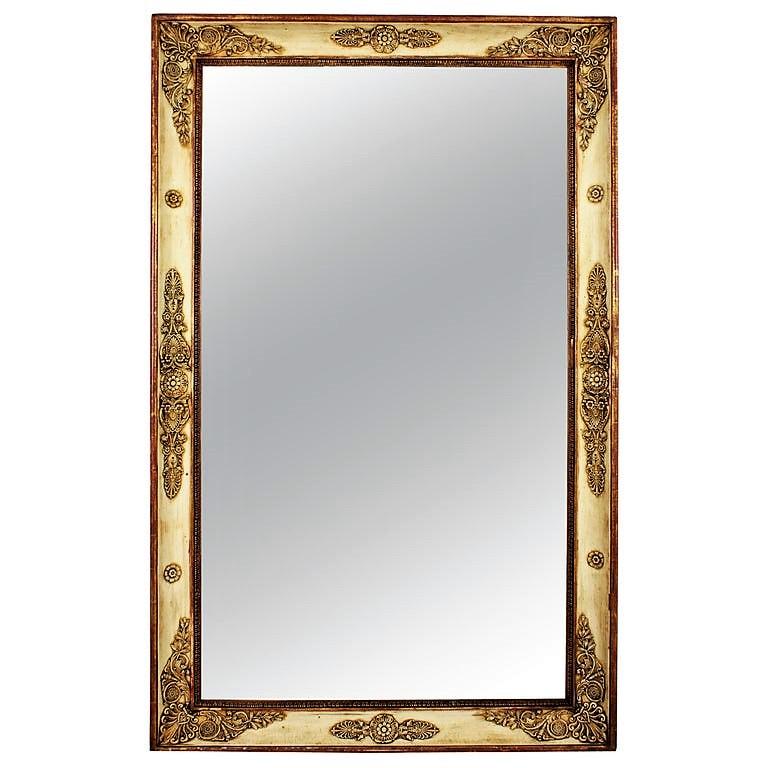 Beautiful Empire period large rectangular mirror with neoclassical relief ornamentation with gilded details and a very nice patina in beige color with red accents, France, circa 1810.
It wears its original antique glass that shows a terrific aged