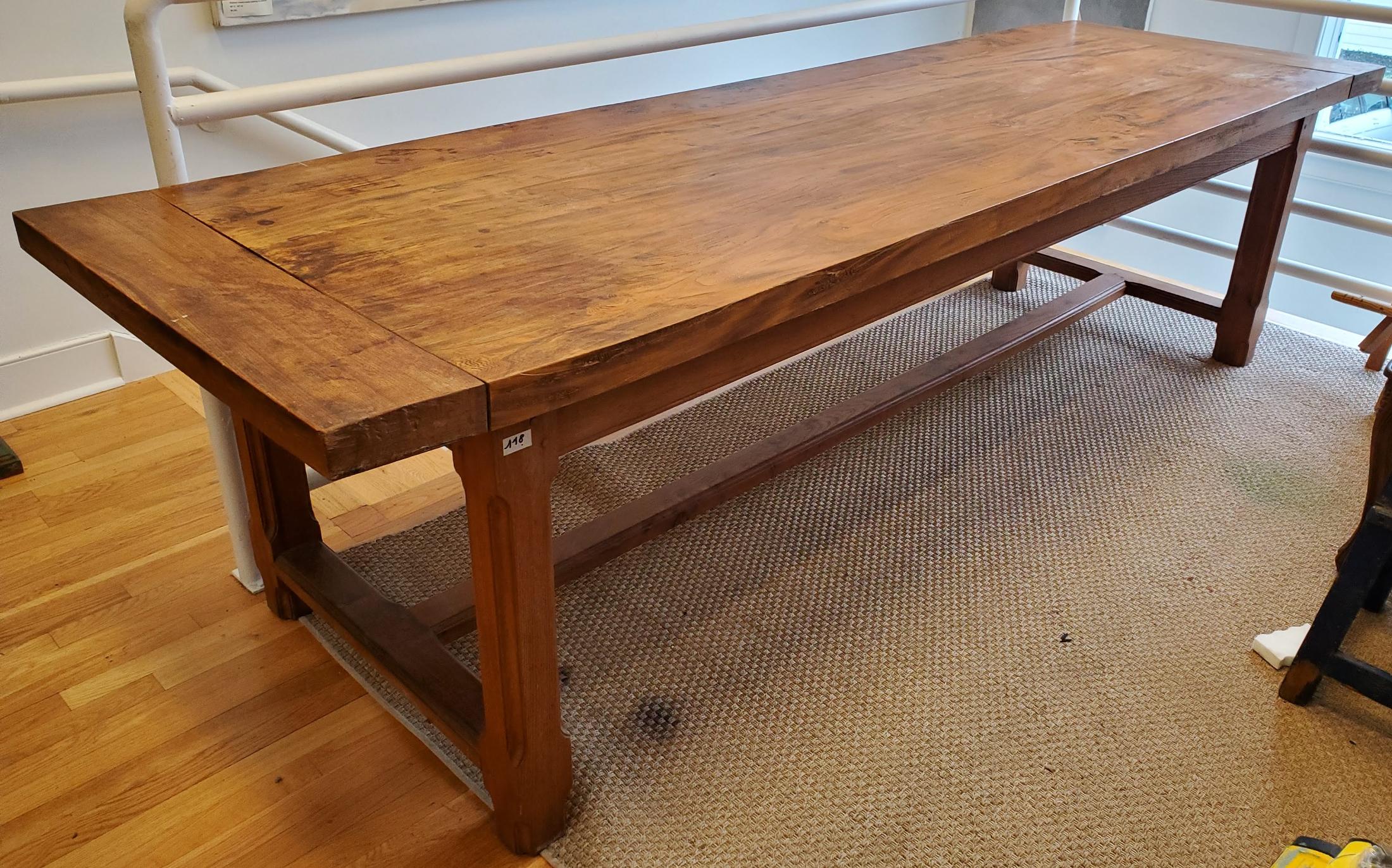 Large early 19th century French Provincial farm house dining table. Thick cleated top over Chamfered legs and stretchers. Made in Brittany of deeply patinated highly figured elm.
France, circa 1840.
Measures: 30” H 113” W 34.5” D.
 