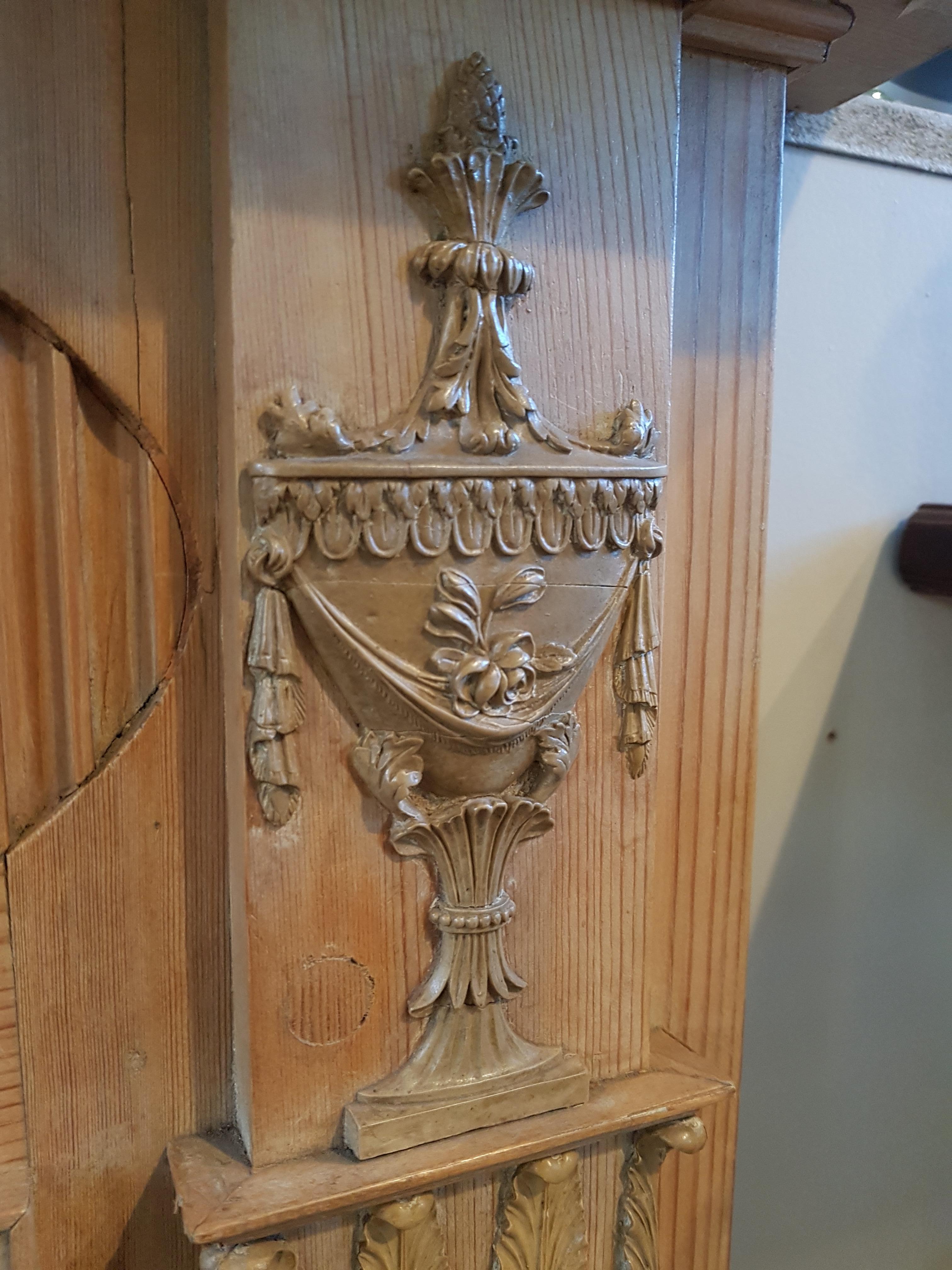 A charming timber fireplace surround salvaged from Edinburgh's historical New Town. A breakfront and moulded shelf sits above a a frieze with a central tablet hosting an open eagle with tendrils of Scottish Thistles, flanked by oval reeded