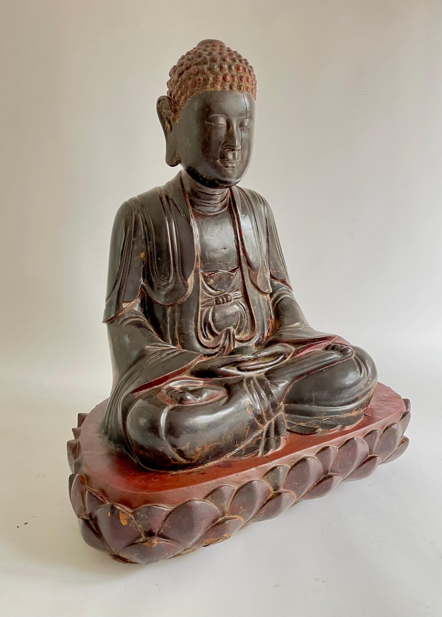 A highly decorative early 19th century Vietnamese carved wooden and polychrome painted Buddha with traces of original gilding, creating a beautiful patina. This Buddha has a beautiful, peaceful, benevolent face, seated in a meditation pose with
