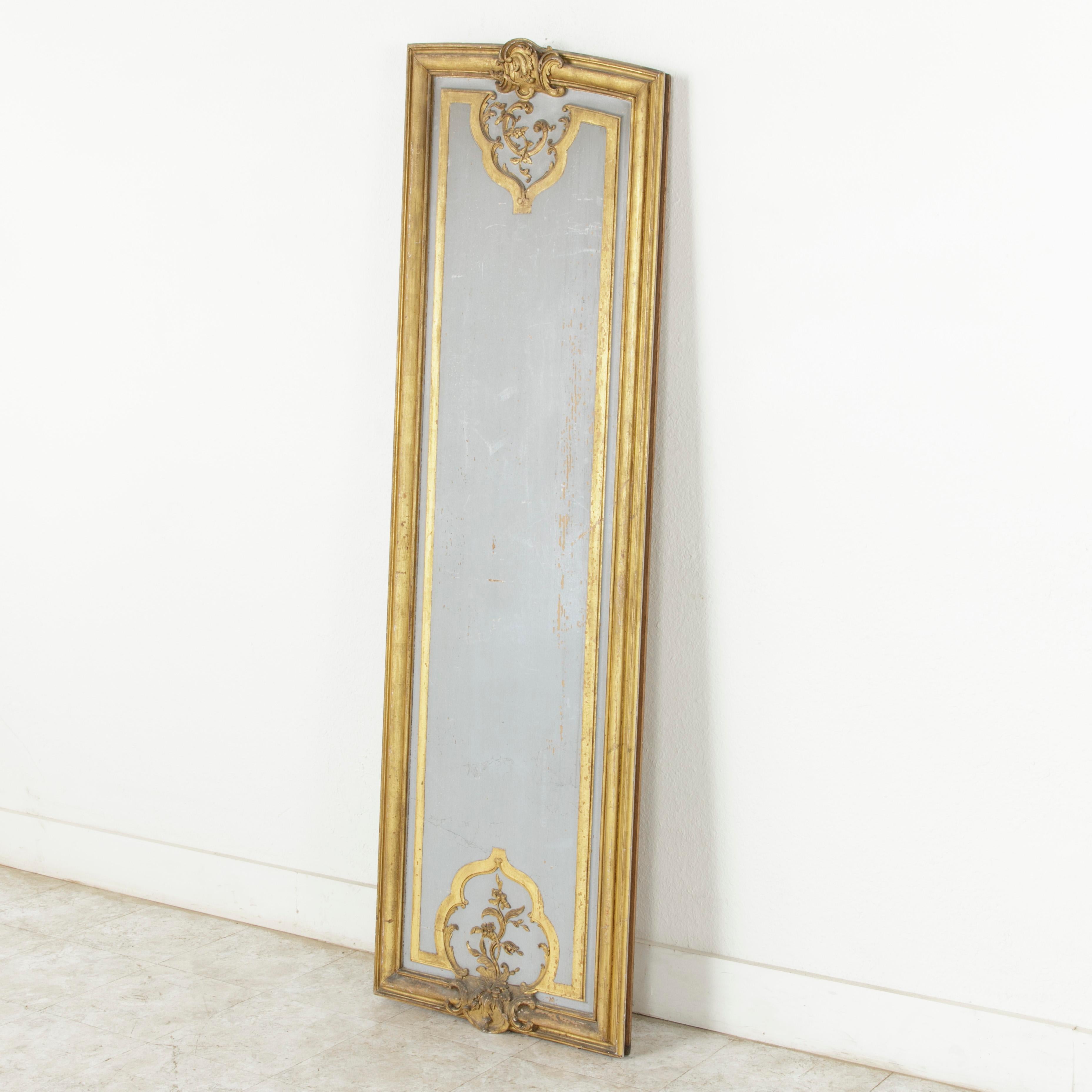 Standing at an impressive 73 inches in height, this large asymmetrical architectural panel from the early 19th century was originally part of the boiseries or paneling in a French manor house. Painted in a Marie Antoinette grey and surrounded by a