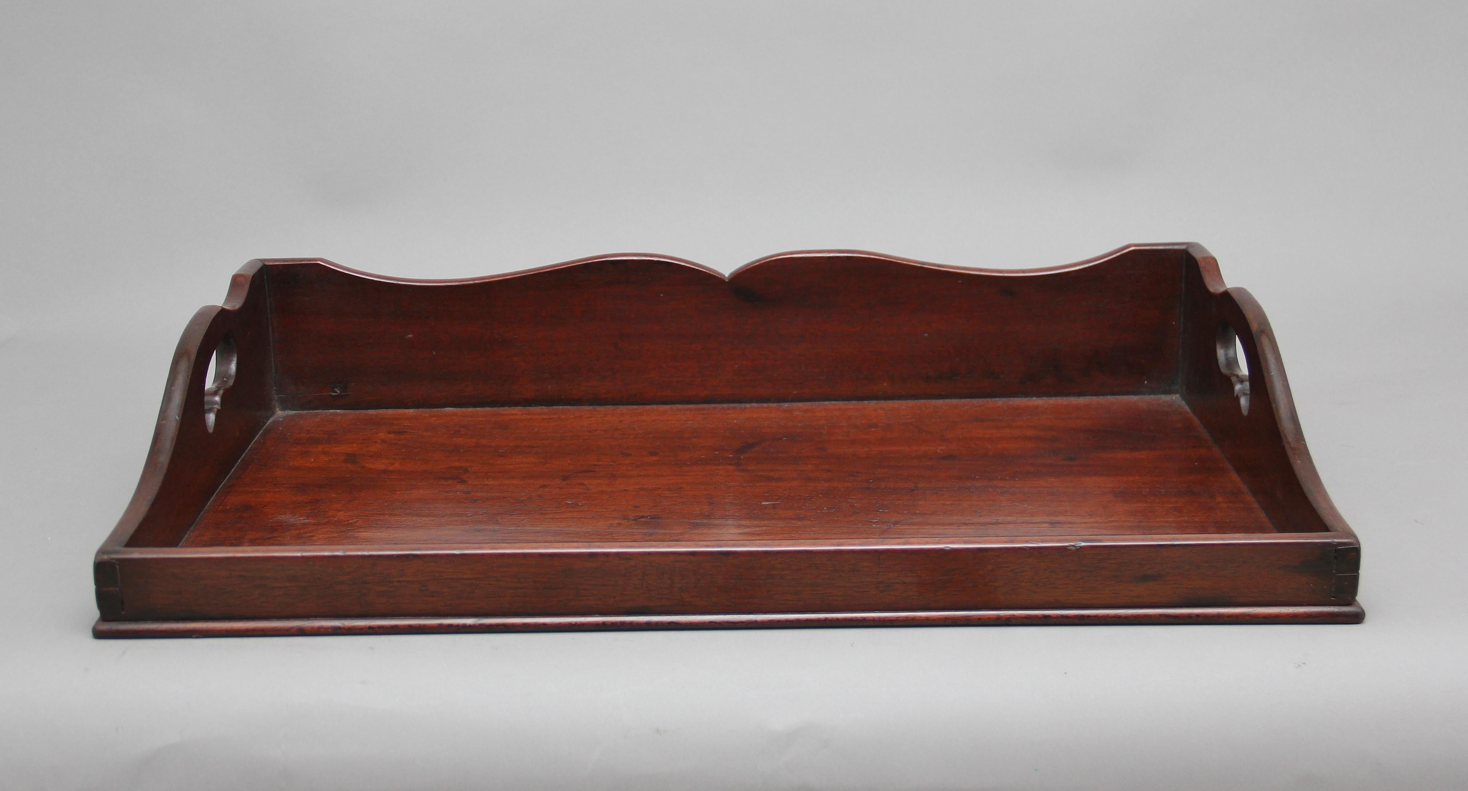 Large early 19th century mahogany tray of rectangular form, surround gallery three quarters raised and with two fret cut carrying handles, circa 1830.