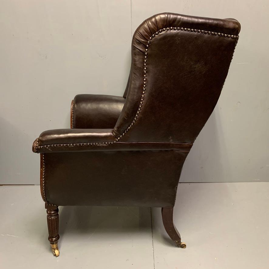 English Large Early 19th Century Regency Buttoned Leather Wing Armchair on Castors For Sale