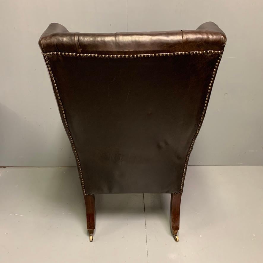 Large Early 19th Century Regency Buttoned Leather Wing Armchair on Castors In Good Condition For Sale In Uppingham, Rutland