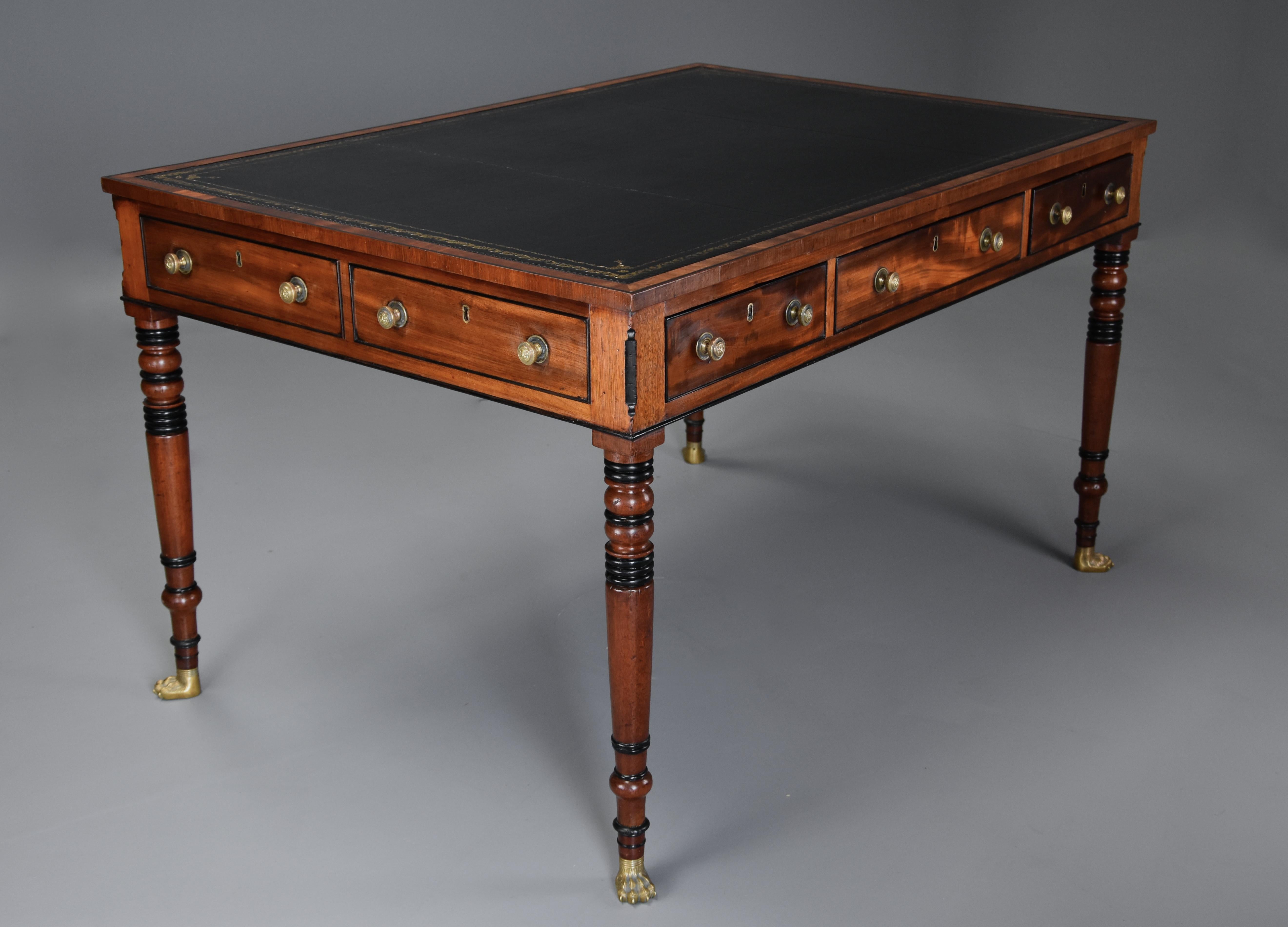 A large early 19th century Regency six-drawer writing table of fine, faded patina (color).

This writing table consists of a finely tooled black leather top surrounded by a mahogany crossbanded edge with ebony line.

This leads down to three