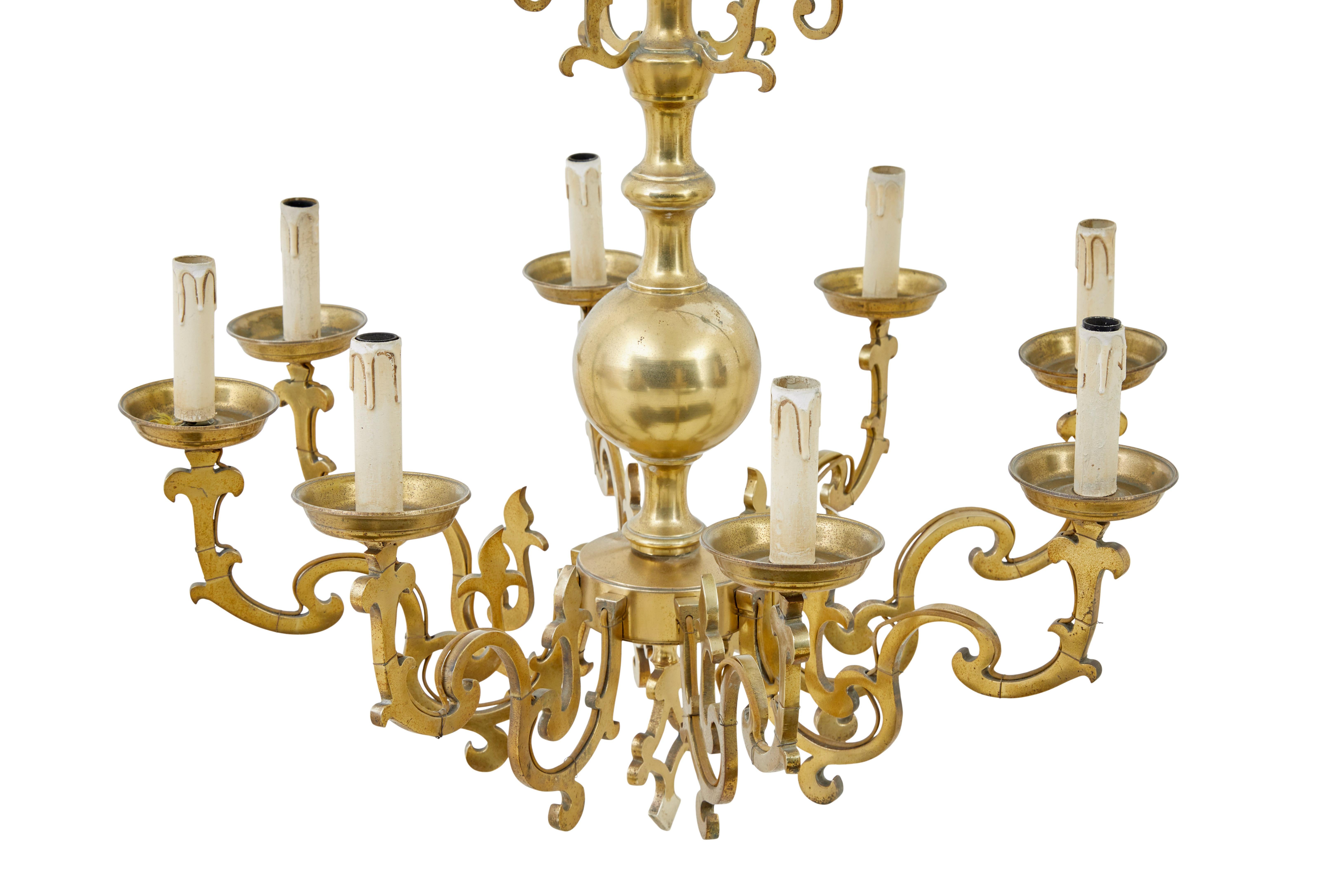 Large early 20th century brass chandelier circa 1920

Fine quality solid brass chandelier.  Central turned body with 8 arms very much in the gothic revival taste.  This light would have been wired for electricity from new.  Further fret cut