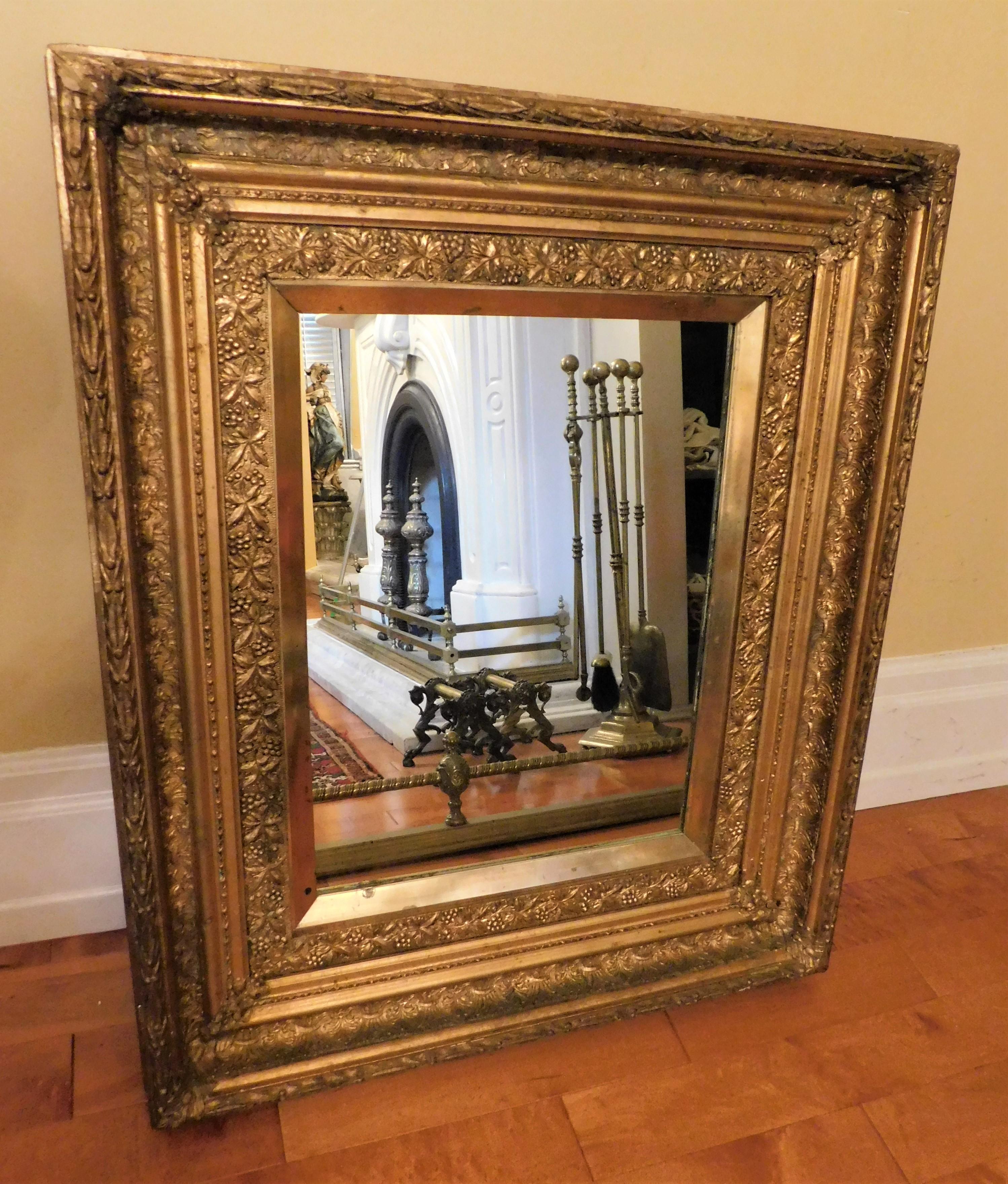 Belgium in a French style gold framed mirror, circa 1910. Beautiful mirror that can be used on a wall or over a fireplace, on a mantel... Or the frame could be used for a painting or a piece of art. Mirror size 17 X 22 X 1 inches, frame size 26.75 X