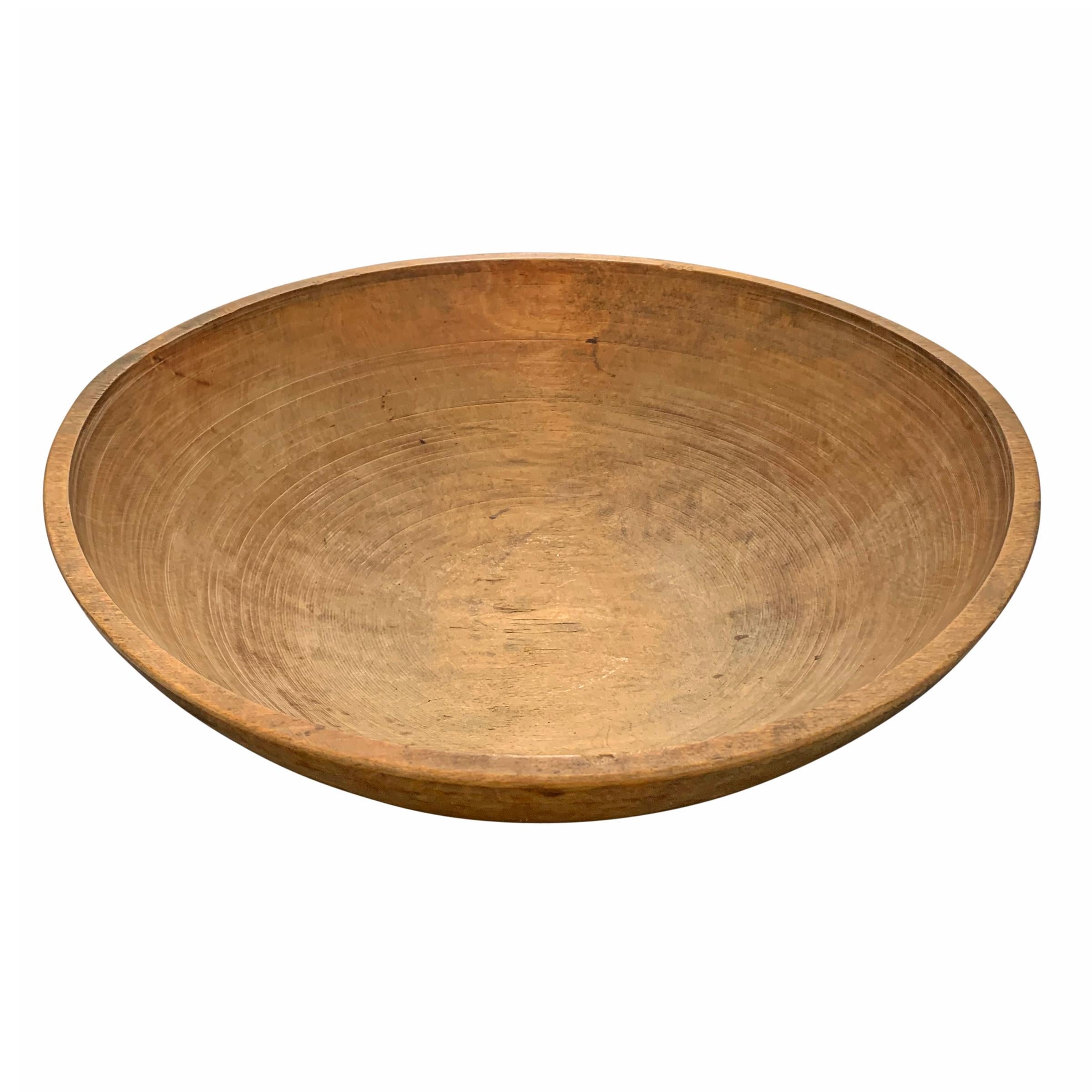 An unusually large early 20th century American turned maple dough bowl with a fantastic patina and wonderful grooves from carving.