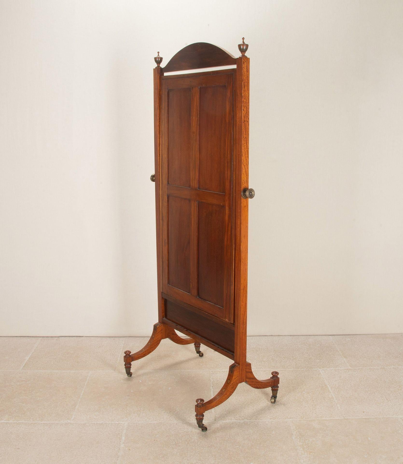 Early 20th Century Edwardian Cheval mirror in the Adams style. Handcrafted from satinwood with hand painted details, mainly floral motifs.
Large adjustable floor standing mirror. Depth of the feet is 56cm.