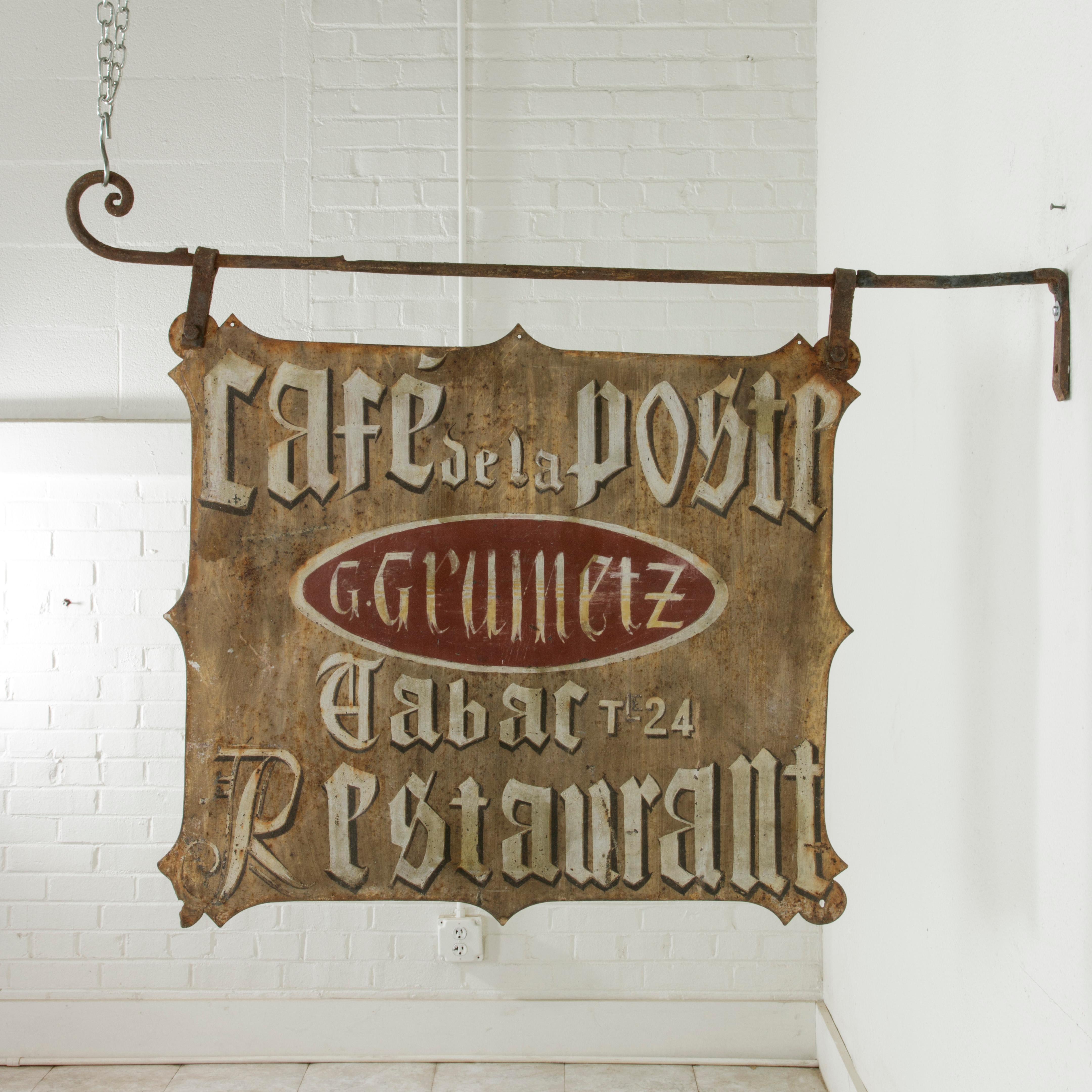 This very large early 20th century French hand-painted iron cafe sign is double faced and is entitled Cafe de la Poste (Post Office Cafe). In the centre on a red background is the name of the proprietor G. Gruinetz. Below his name are the French