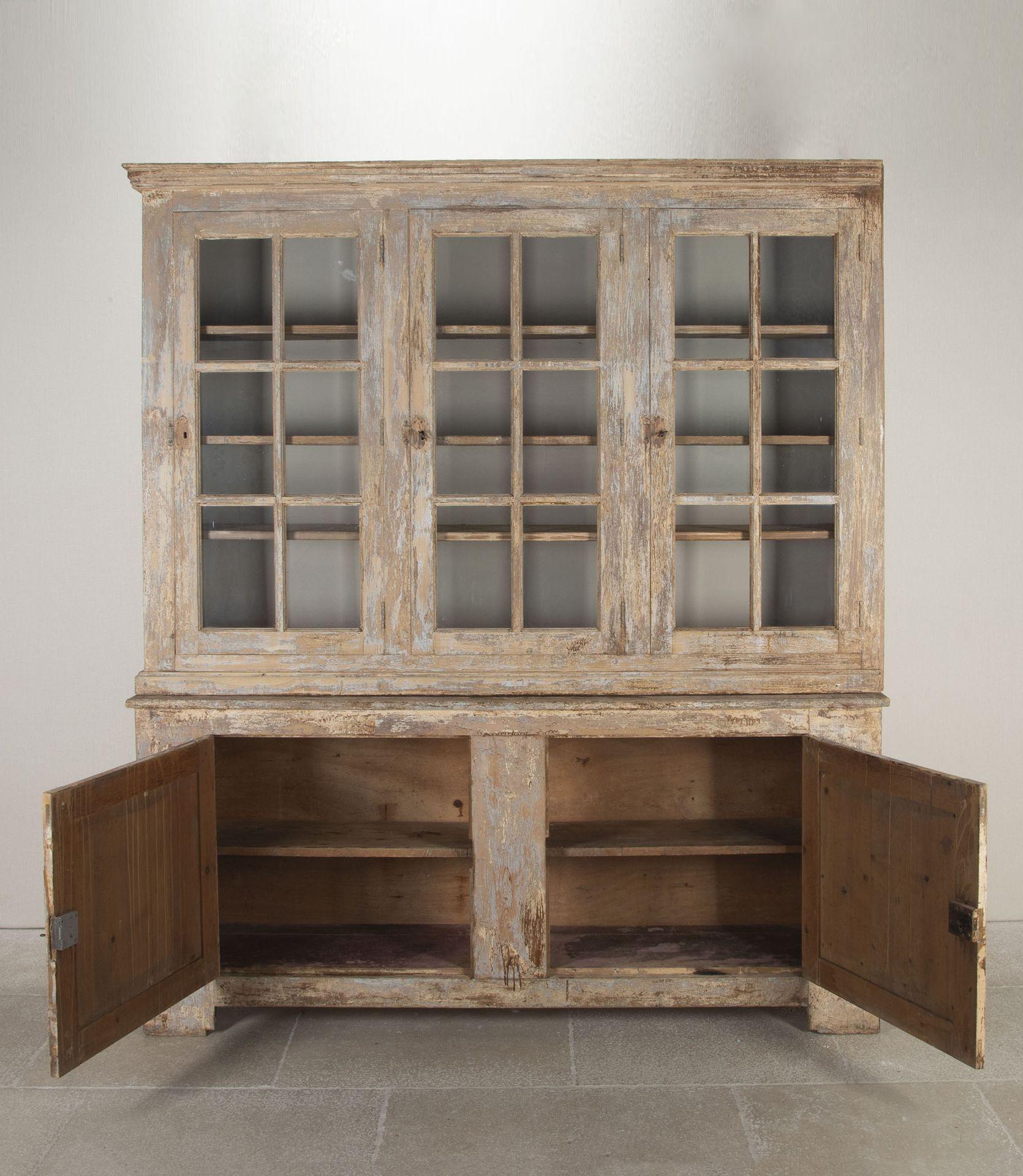 Large early 20th Century French buffet a deux corps or cupboard.A glazed upper part with three doors. Most of the glass is original but two panes have been replaced. This lovely piece with a worn and attractive finish has been stripped down to