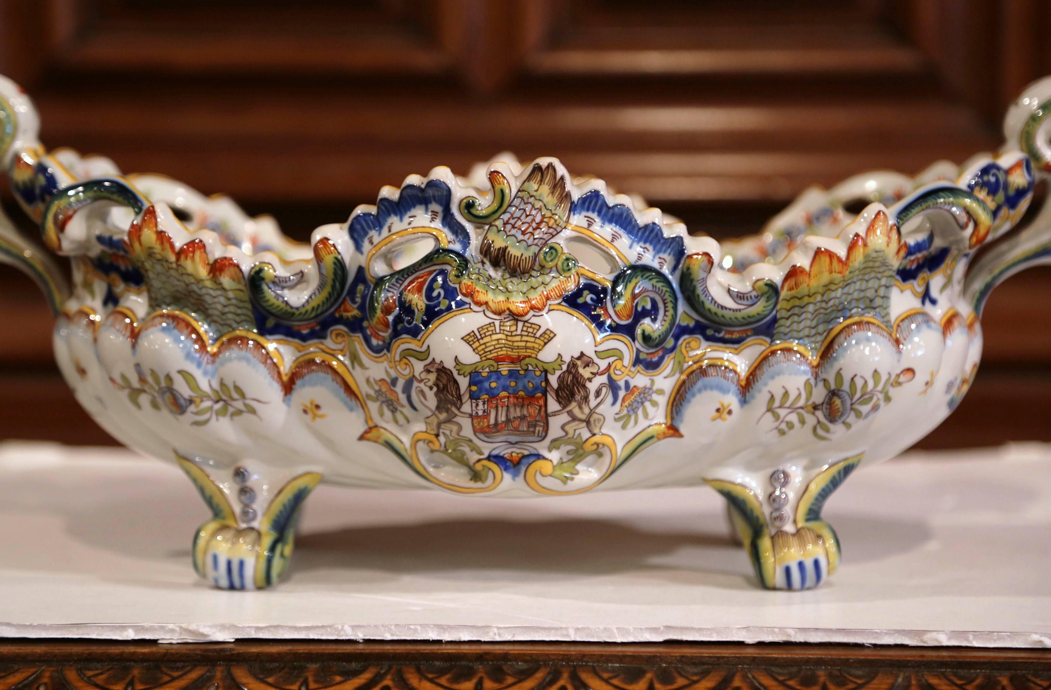 Decorate a table or a mantel with this elegant, Louis XV bowed jardinière. Crafted in northern France, circa 1920, and oblong in shape, this antique planter sits on four scrolled feet; the large vessel features handles on both sides and expressive,