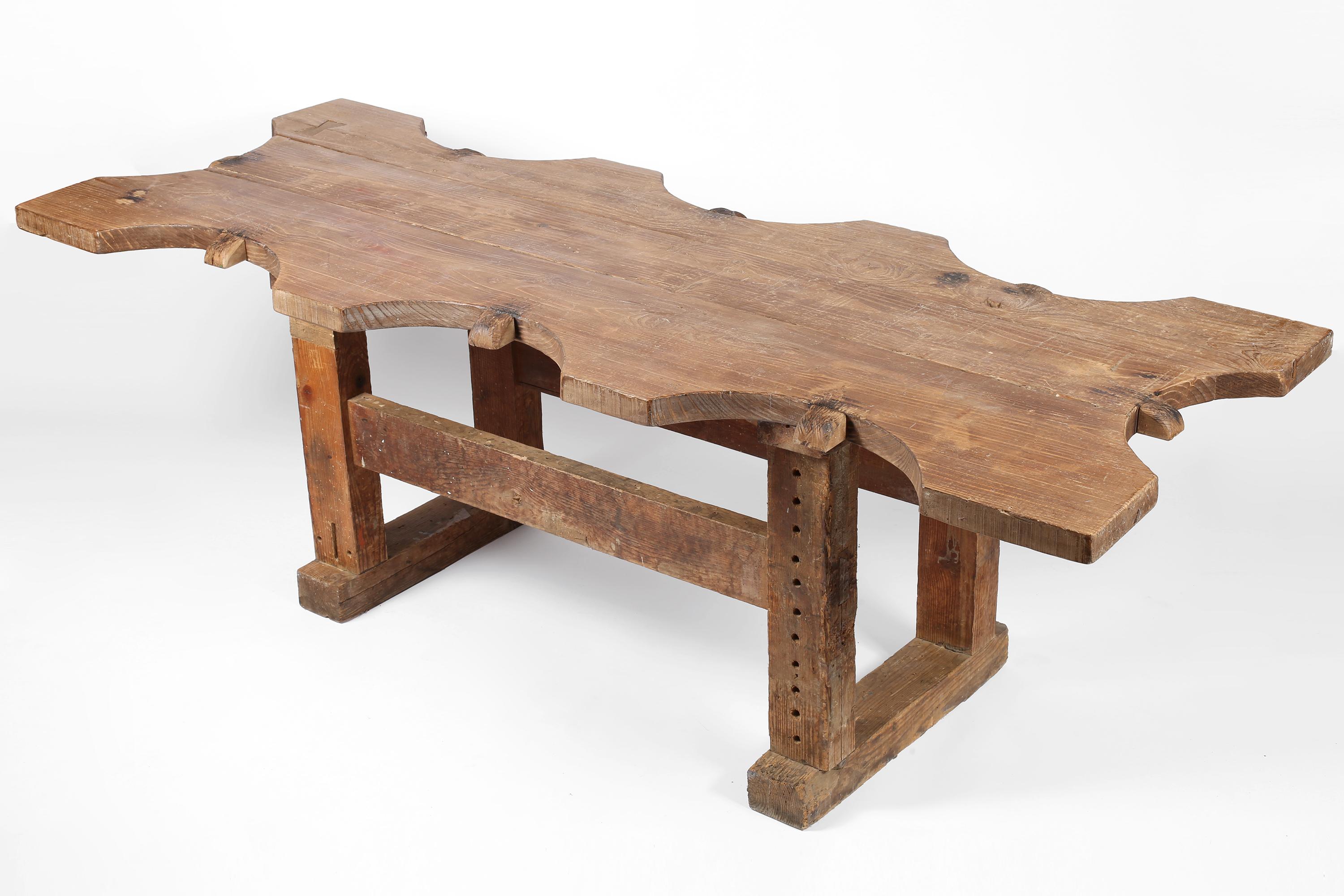 A monumental early 20th century jewellers work table in pine timber which would have originally accommodated eight artisans in its utilitarian past. Heavily patinated and bearing the hallmarks of its history  - suitable as a large centre/console