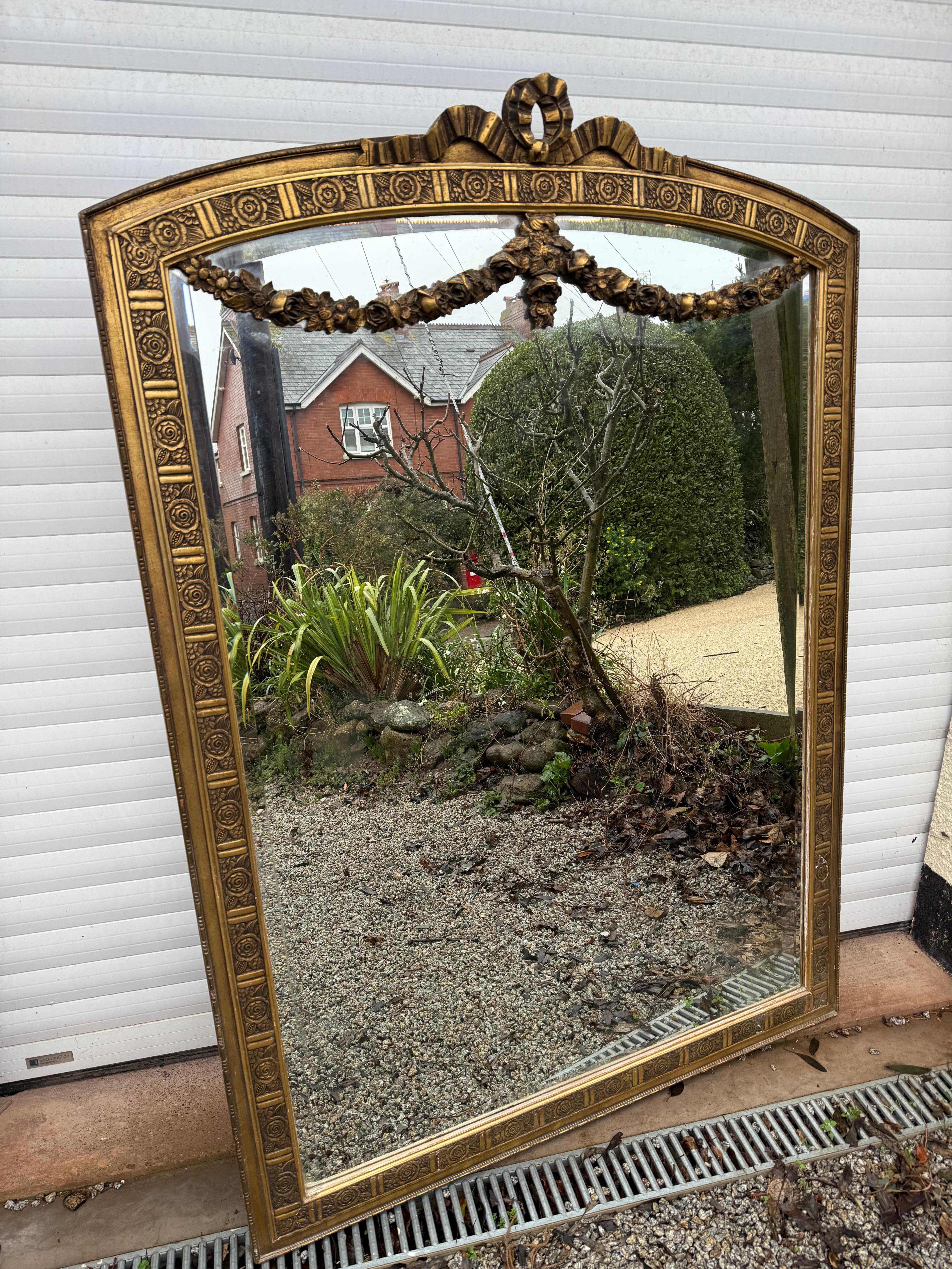 Very decorative early 20th century gilded over mantle 

French circa 1920’s with original gilding , bevelled mirror and back boards 

A little foxing to the mirror 

120 cms or 47 inches 
168 cms or 66 inches