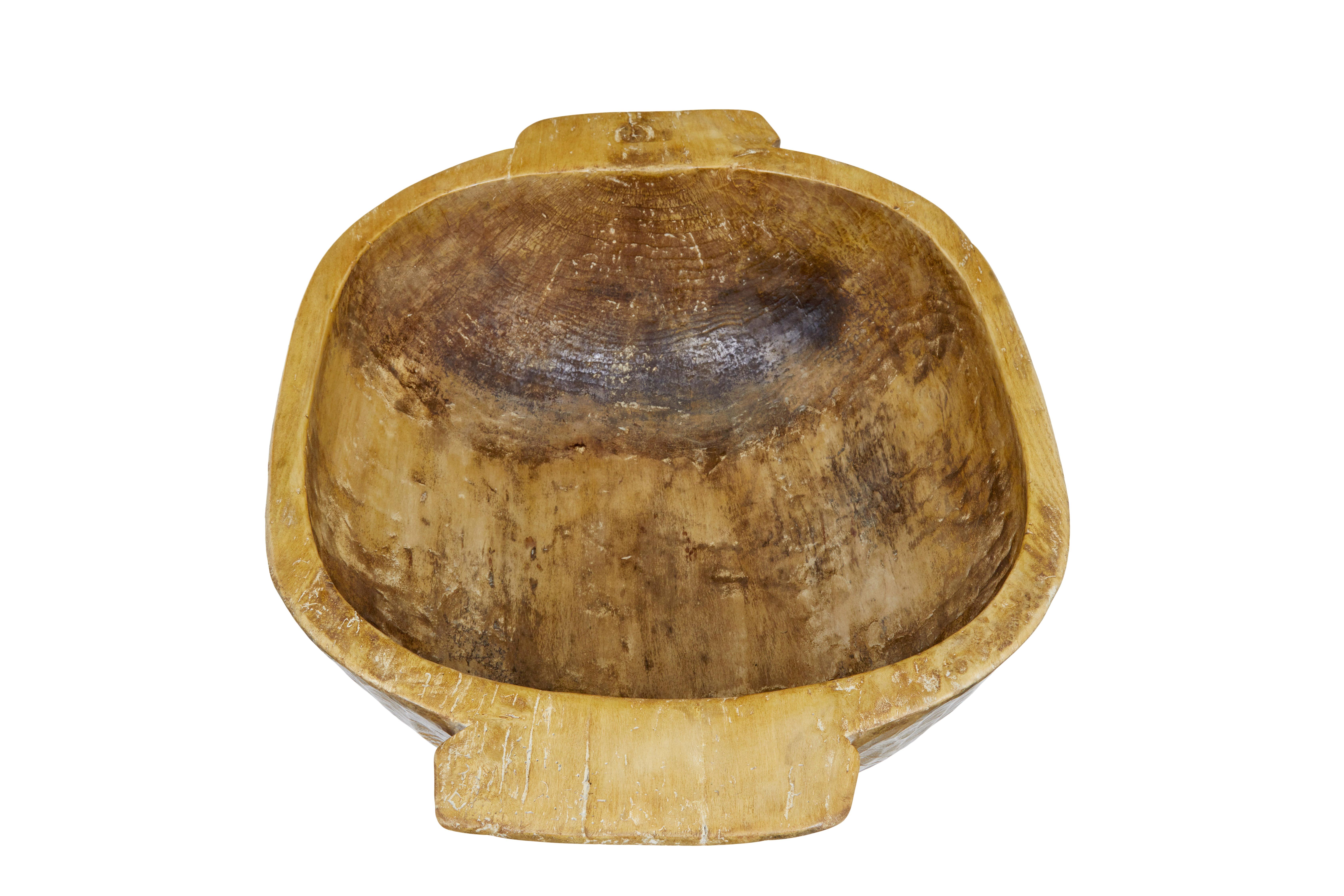 Large early 20th century hand carved bowl circa 1900.

These large bowls were hand carved from solid trunks to be used as livestock feeders in eastern europe.  There is no evidence that this was used as such, but it now provides and excellent piece