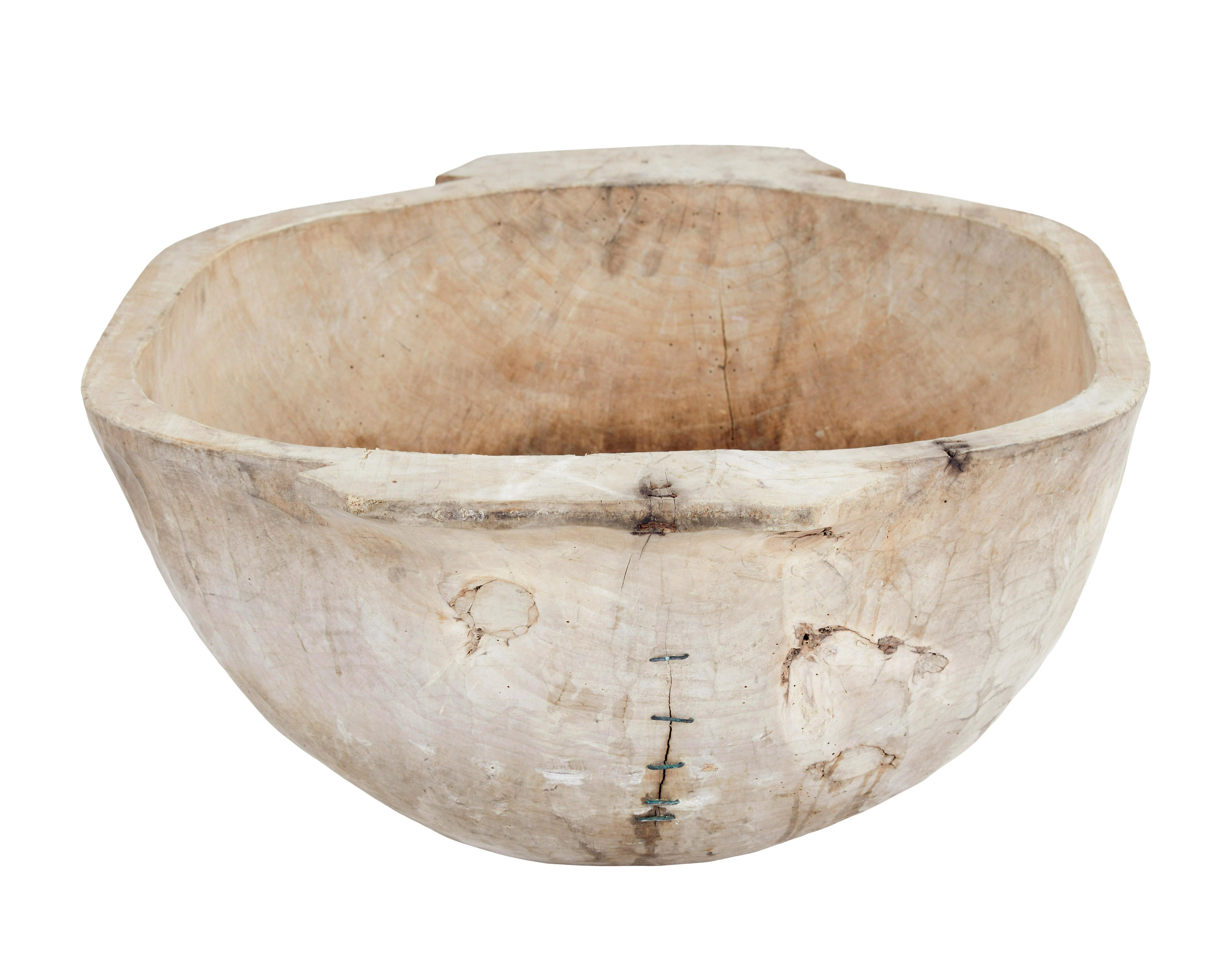 Early 20th century hand carved solid wood vessel circa 1900.

Here we have a large over sized bowl, which would have been used to feed livestock at the turn of the 20th century.

Hand carved from a solid piece of wood, with a carrying handle each