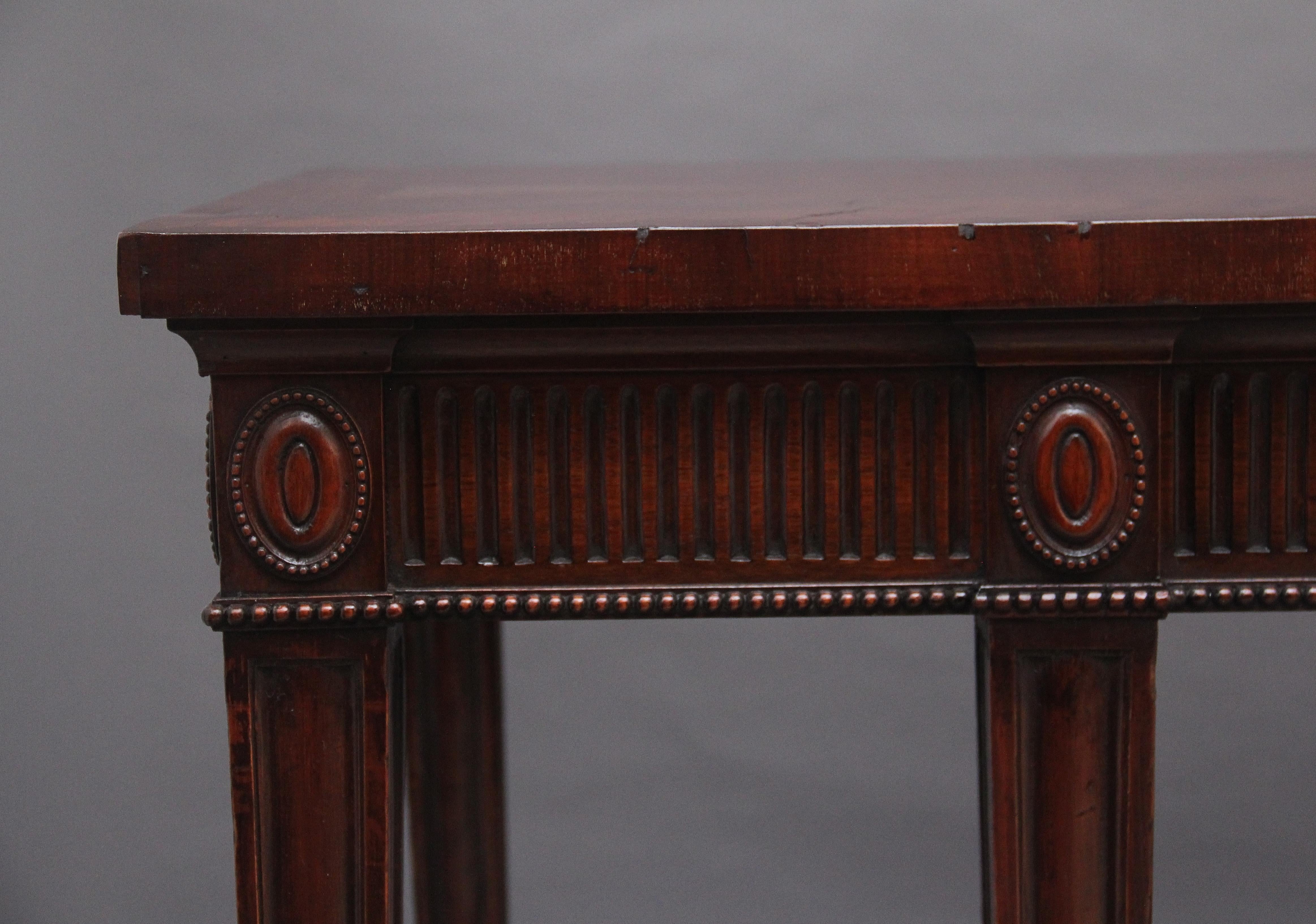 A large and impressive early 20th century mahogany serving table in the Adam style, the wonderfully crossbanded figured top above a fluted frieze, the frieze decorated with carved oval patraes, the sides of the serving table has the same wonderful