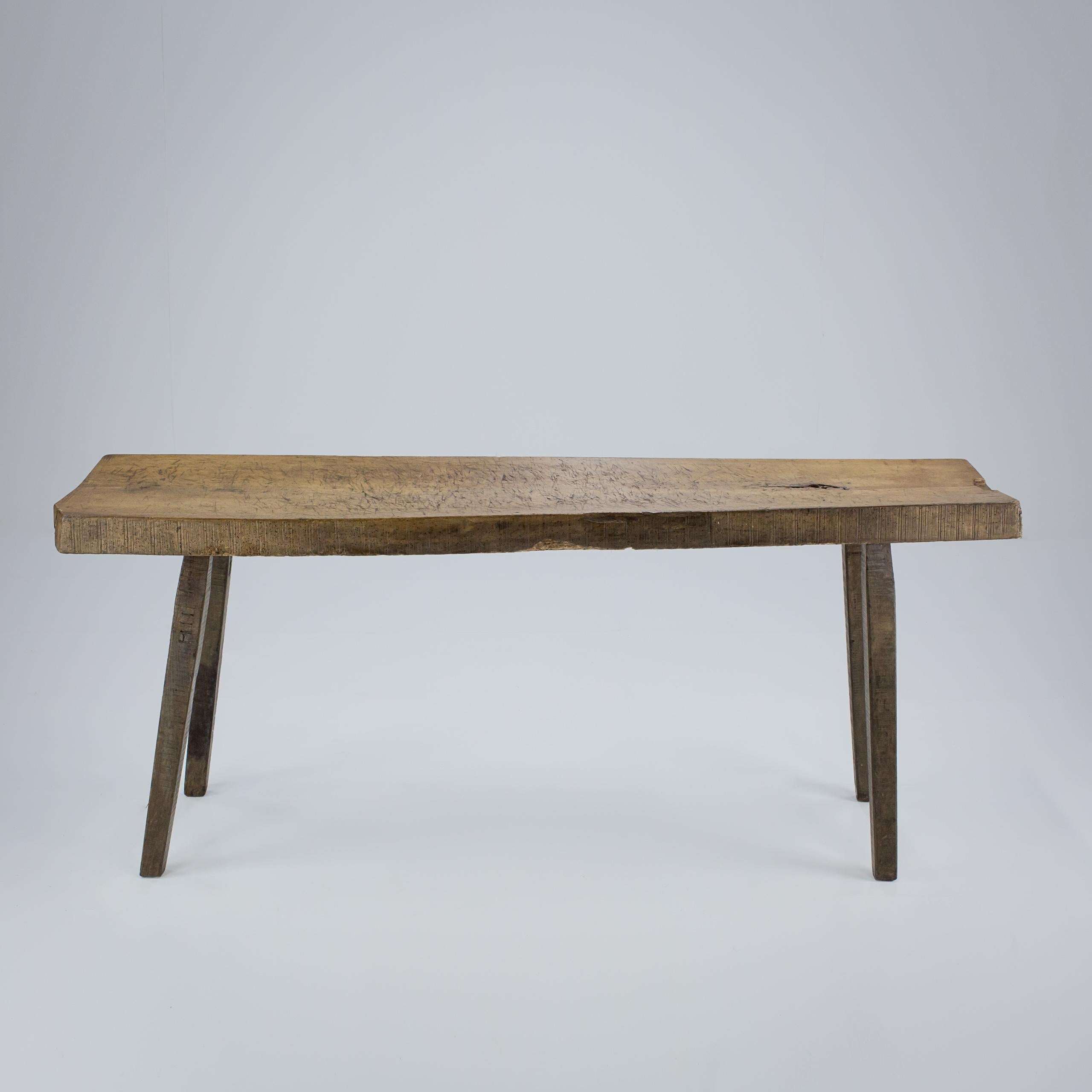 Large single plank, slab top table or pig bench. Unusual full height could be used as a dining table or large console. Four Primitive staked legs each with carved numerals. Well patinated, with marks from use beech slab top. 9cm thick slab. France
