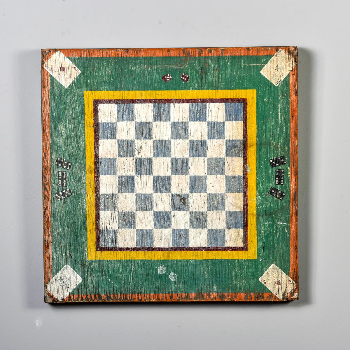 Found in England, this circa 1900 large wooden game board is over 28” square. Original paint features checkerboard center with dice and dominoes in the green border and aces in each corner. Honest wear to paint. Fun authentic folk art piece.