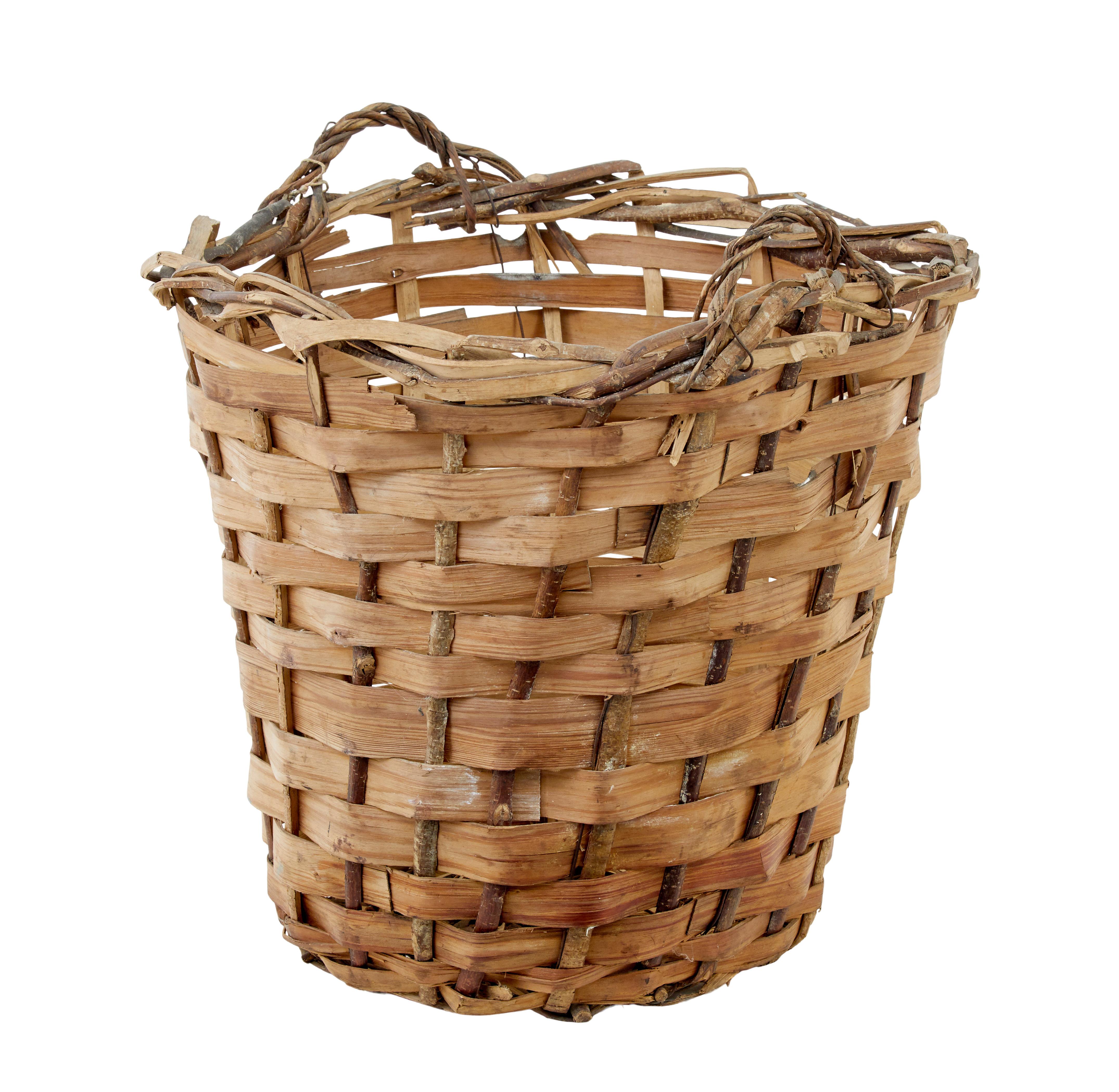 Large early 20th century woven basket circa 1910.

Scandinavian woven pine basket with a softwood frame.  Ideal for use as a light use log bin, or for storing those shoes in the cloakroom.

Some minor losses and splits, but structurally sound.