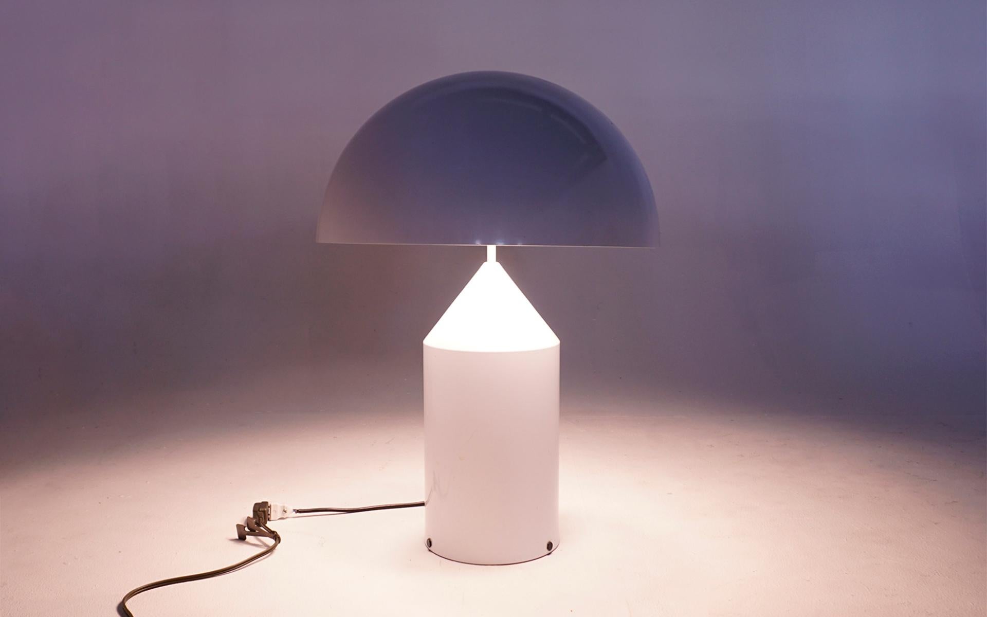 Early production white enameled steel table lamp designed by Vico Magistretti. This example was purchased by the original owner, an architect, in London in the 1980s. It has been with that one owner ever since. Beautiful example in very good to