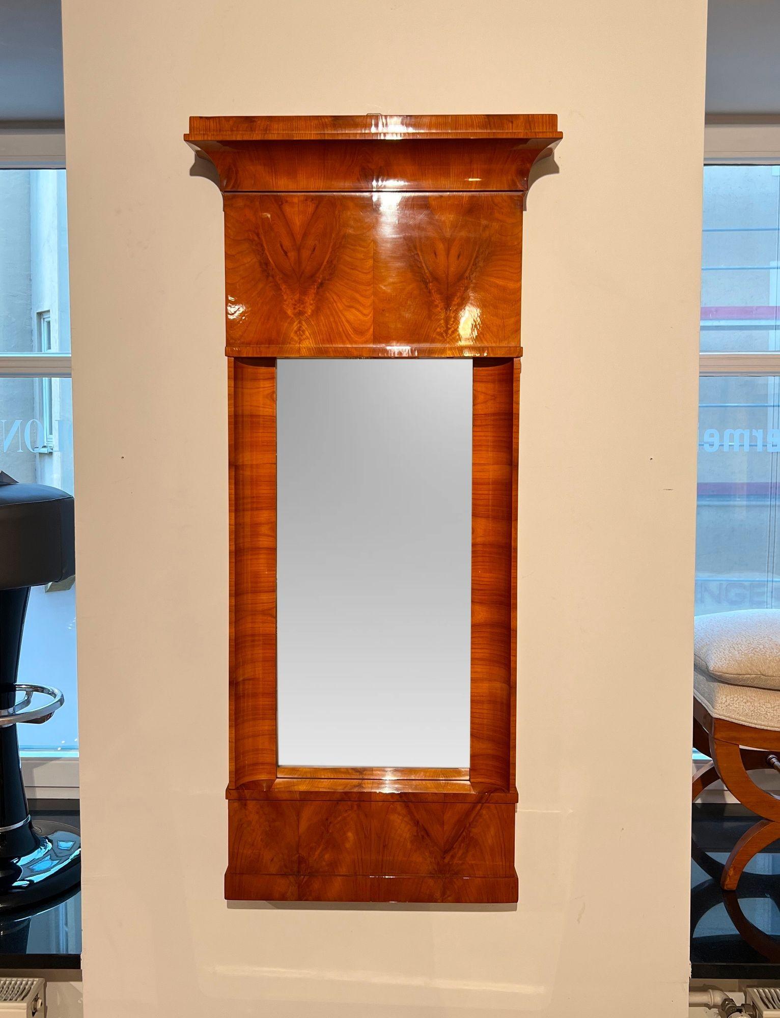 Large early neoclassical Biedermeier wall mirror, cherry veneer, South Germany circa 1820
 
Cherry veneered on soft wood. Concave pilaster strips. Very good condition, patinated.
 
Dimensions: H 138,5 cm x W 63,4 /51,8 cm x D 13 / 7 cm.