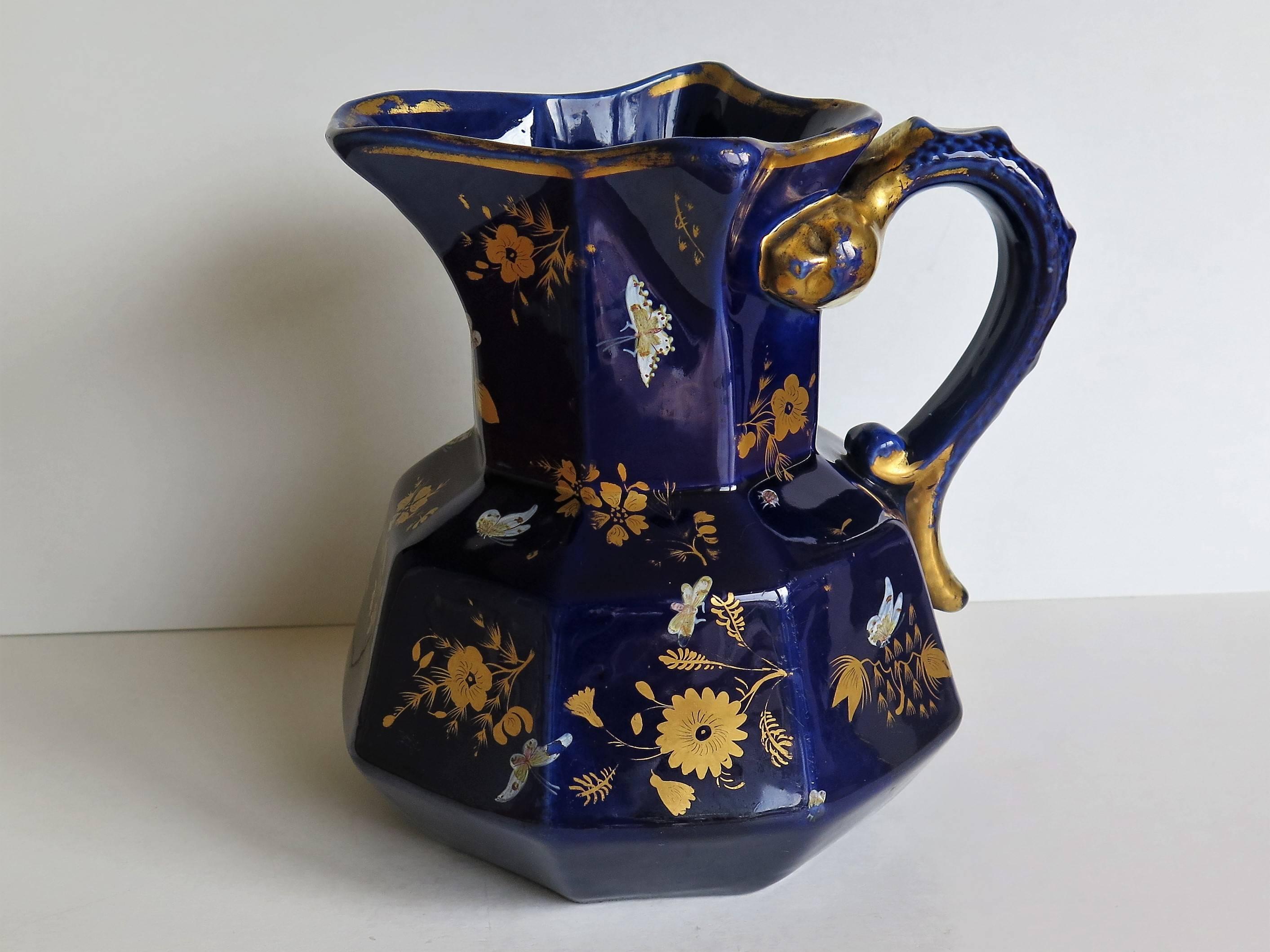 This is a large ironstone jug or pitcher in the Hydra Shape with a rare pattern, made by Mason's, of Lane Delph, Staffordshire, England, Circa 1825. 

The jug is octagonal with a good snake loop handle.

The piece is richly hand-decorated in gold