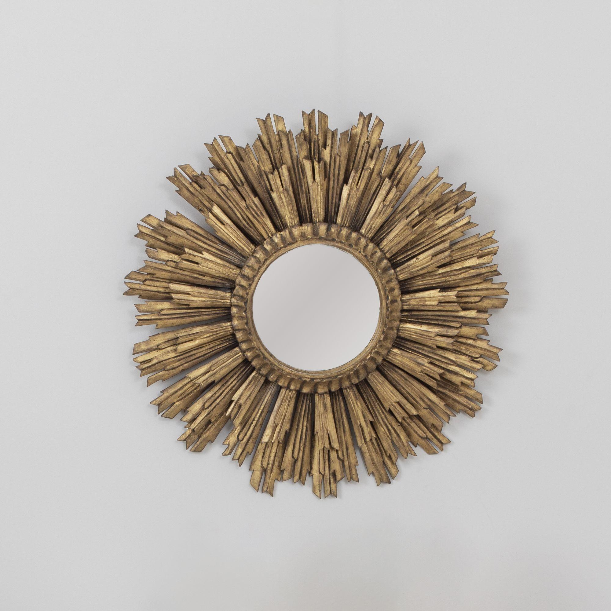 Early to mid 20th century French sunburst mirror in the Art Deco style, three layers of hand-carved rays, original giltwood and mirror plate, circa 1930-50.
